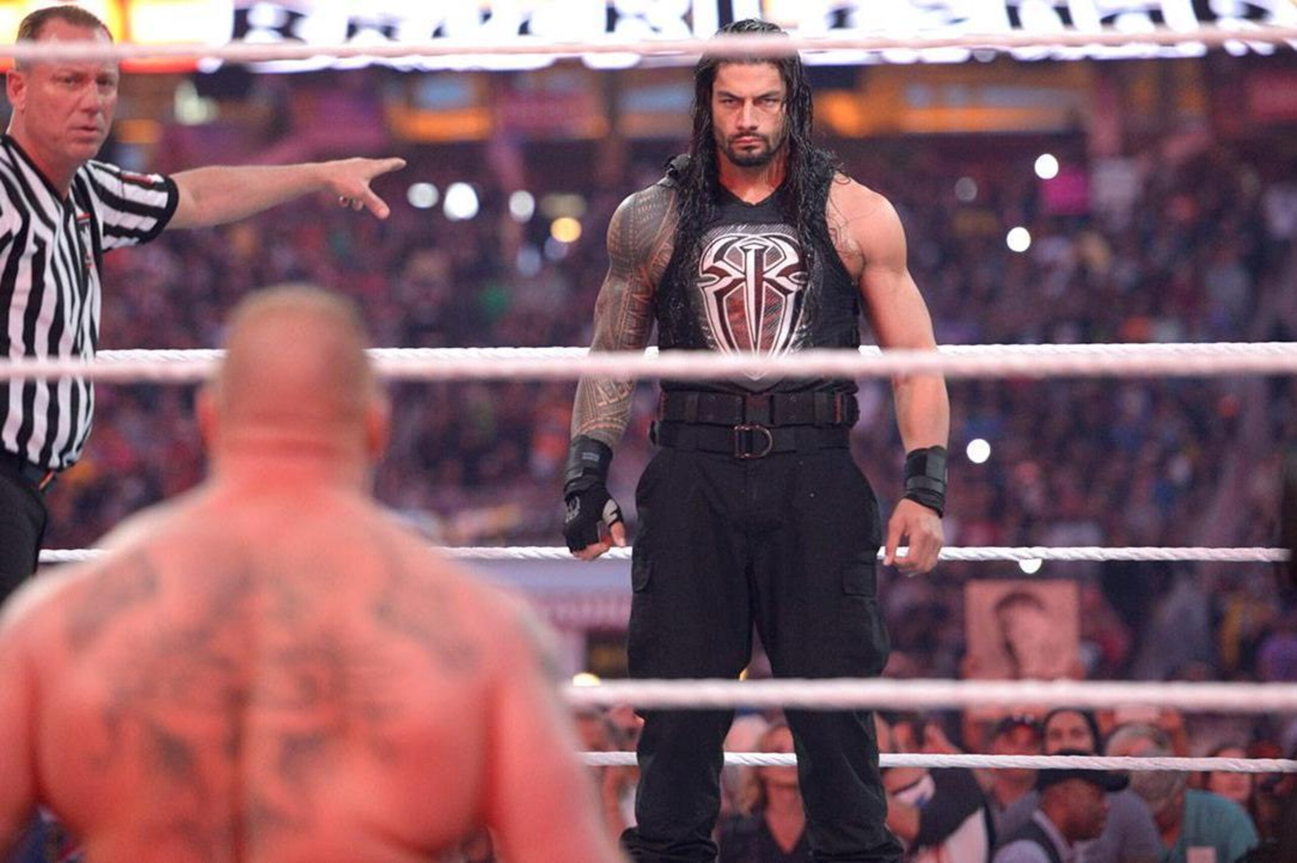 Brock Lesnar stares down Roman Reigns.