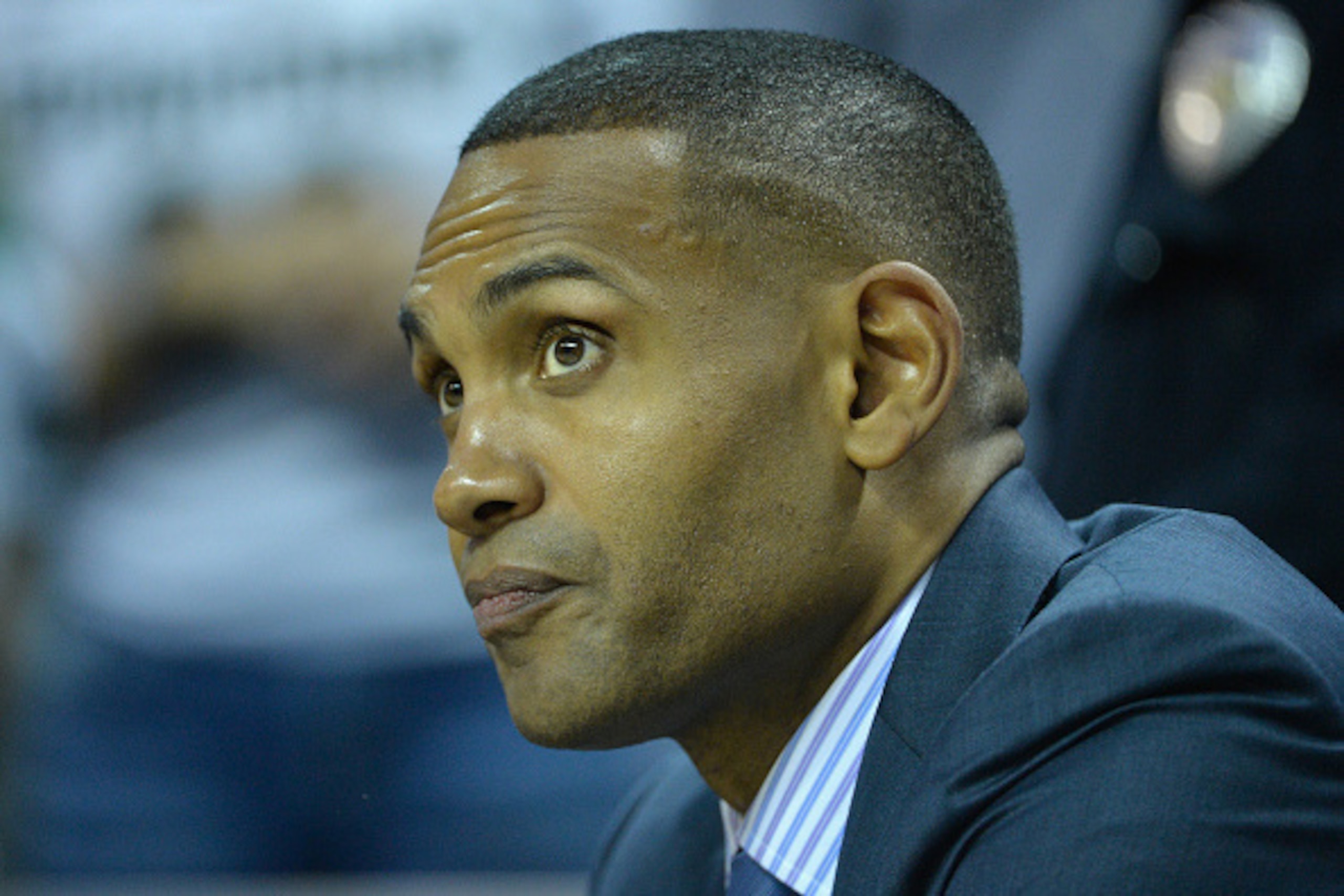 CHARLOTTE, NC - MARCH 20:  College basketball analyst, Grant Hill, watches on before the game between the Georgia Bulldogs and Michigan State Spartans during the second round of the 2015 NCAA Men's Basketball Tournament at Time Warner Cable Arena on March