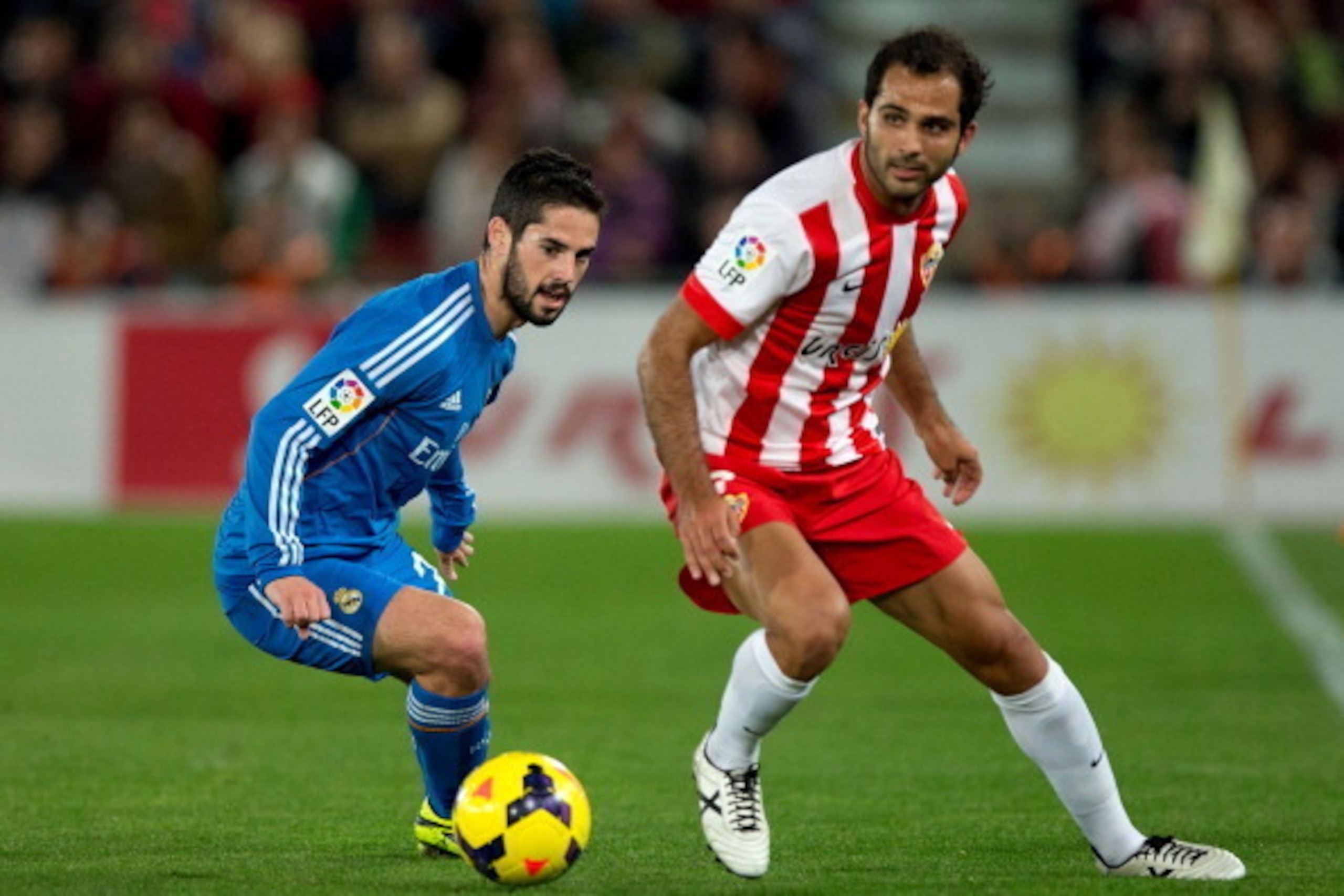 ALMERIA, SPAIN - NOVEMBER 23: Francisco Roman Alarcon alias Isco (L) of Real Madrid CF competes for the ball with Jose Antonio Garcia Rabasco, alias Verza (R) of Almeria UD during the La Liga match between UD Almeria and Real Madrid CF at Estadio de Los J