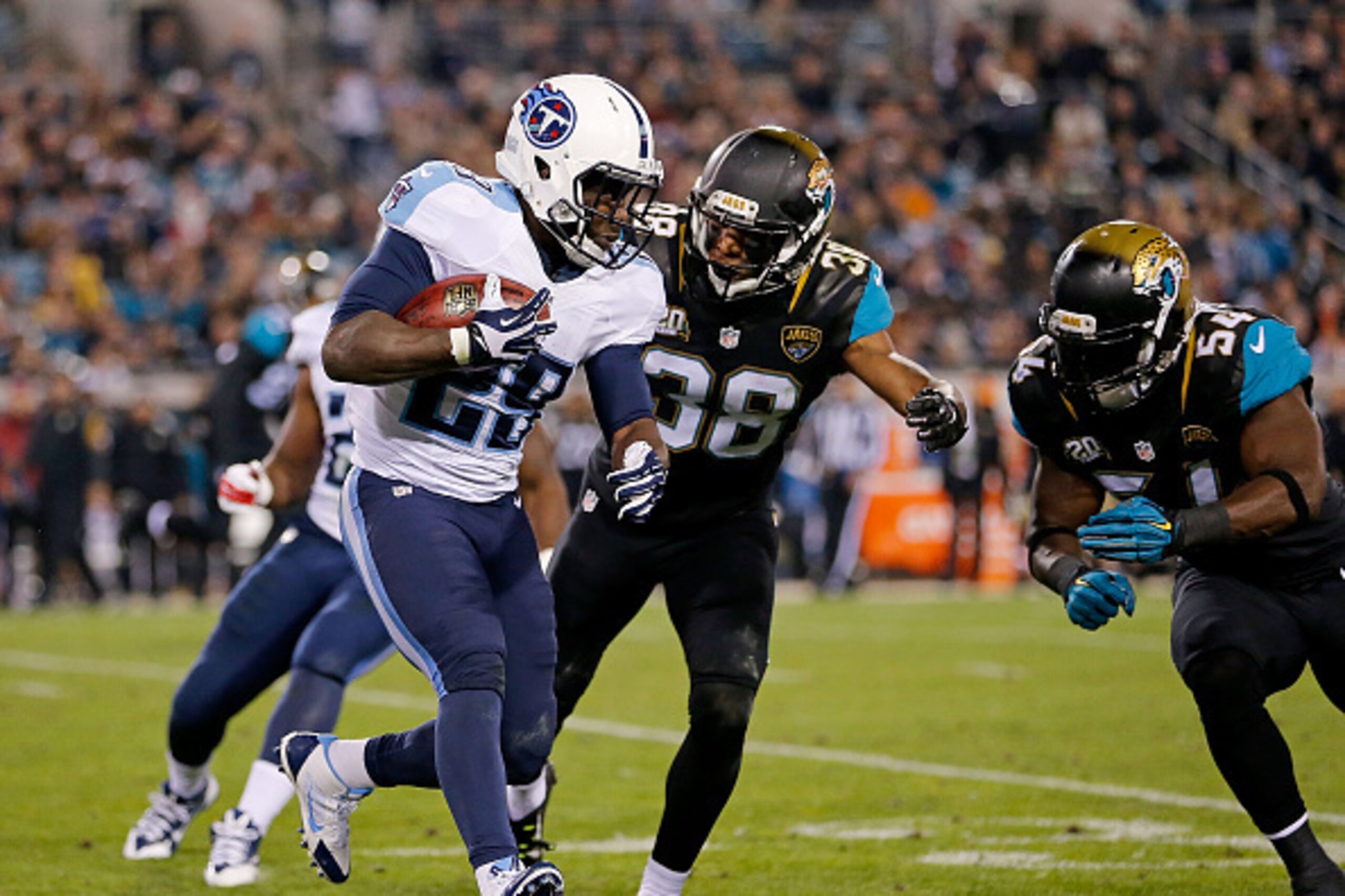 JACKSONVILLE, FL - DECEMBER 18: Leon Washington #29 of the Tennessee Titans carries as Tommie Campbell #38 and Jeremiah George #54 of the Jacksonville Jaguars defend during the game at EverBank Field on December 18, 2014 in Jacksonville, Florida. (Photo JACKSONVILLE, FL - DECEMBER 18: Leon Washington #29 of the Tennessee Titans carries as Tommie Campbell #38 and Jeremiah George #54 of the Jacksonville Jaguars defend during the game at EverBank Field on December 18, 2014 in Jacksonville, Florida. (Photo
