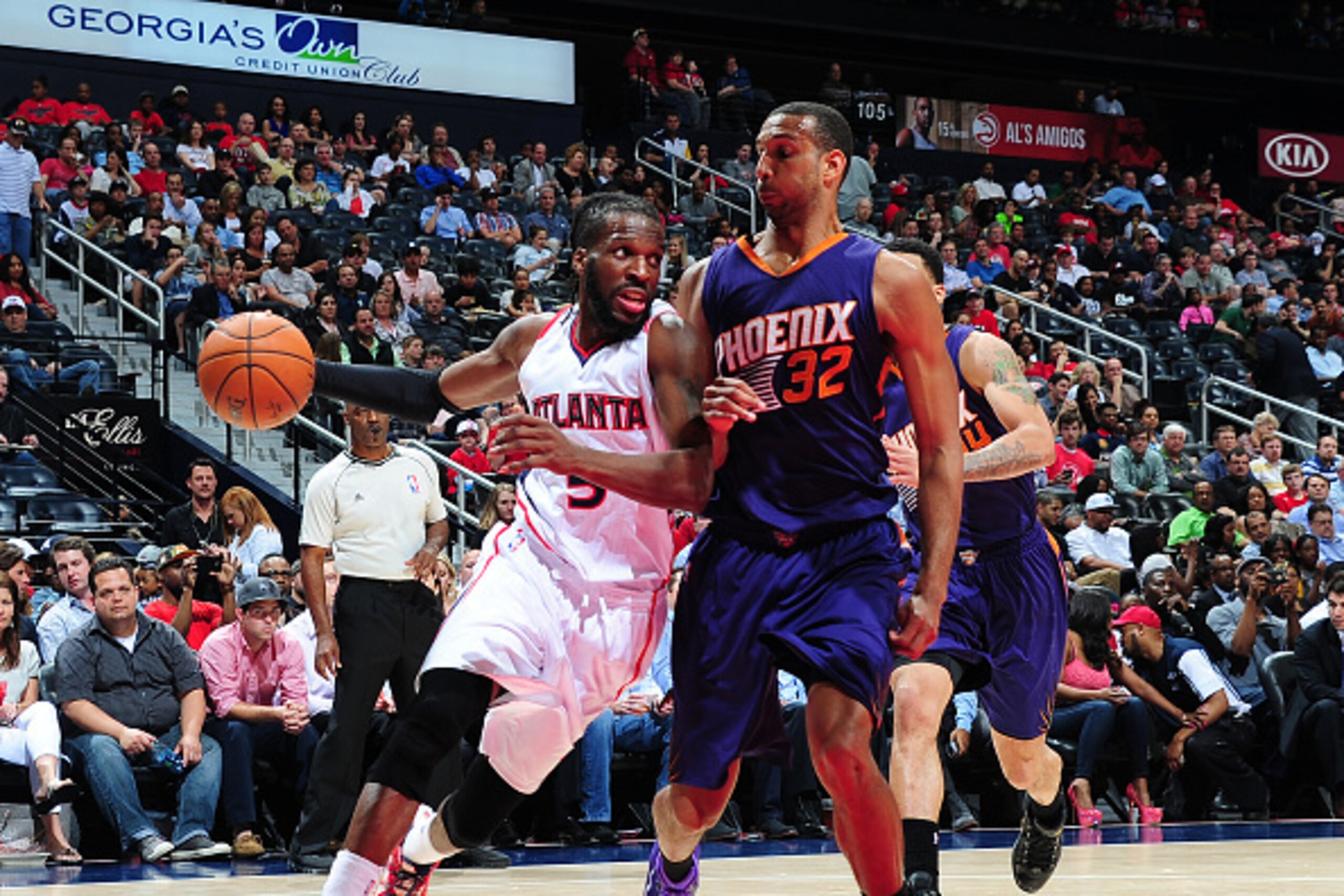 ATLANTA, GA - APRIL 7:  DeMarre Carroll #5 of the Atlanta Hawks handles the ball against Brandan Wright #32 of the Phoenix Suns on April 7, 2015 at Philips Arena in Atlanta, Georgia.  NOTE TO USER: User expressly acknowledges and agrees that, by downloadi