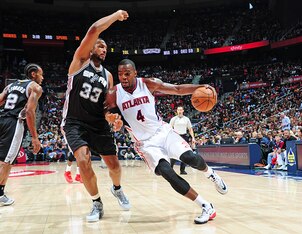 ATLANTA, GA - MARCH 22:  Paul Millsap #4 of the Atlanta Hawks handles the ball against Boris Diaw #33 of the San Antonio Spurs on March 22, 2015 at Philips Arena in Atlanta, Georgia.  NOTE TO USER: User expressly acknowledges and agrees that, by downloadi