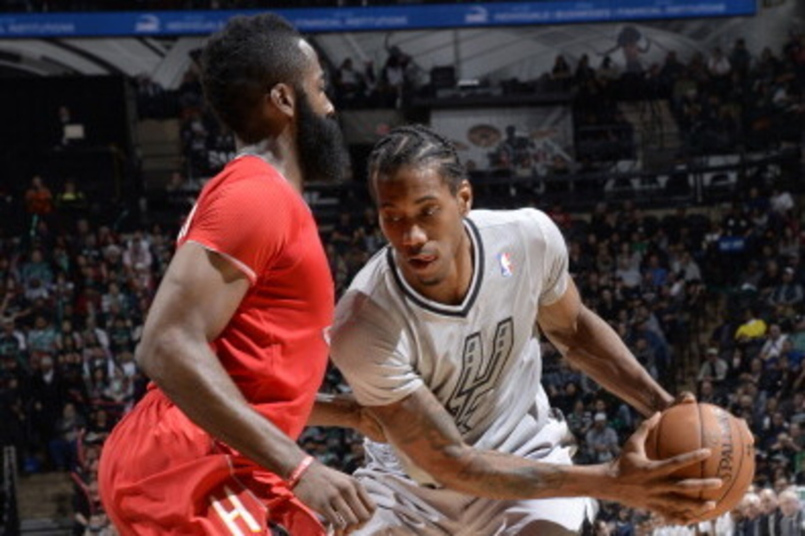 SAN ANTONIO, TX - DECEMBER 25: Kawhi Leonard #2 of the San Antonio Spurs handles the ball against James Harden #13 of the Houston Rockets on December 25, 2013 at the AT&T Center in San Antonio, Texas. NOTE TO USER: User expressly acknowledges and agrees t
