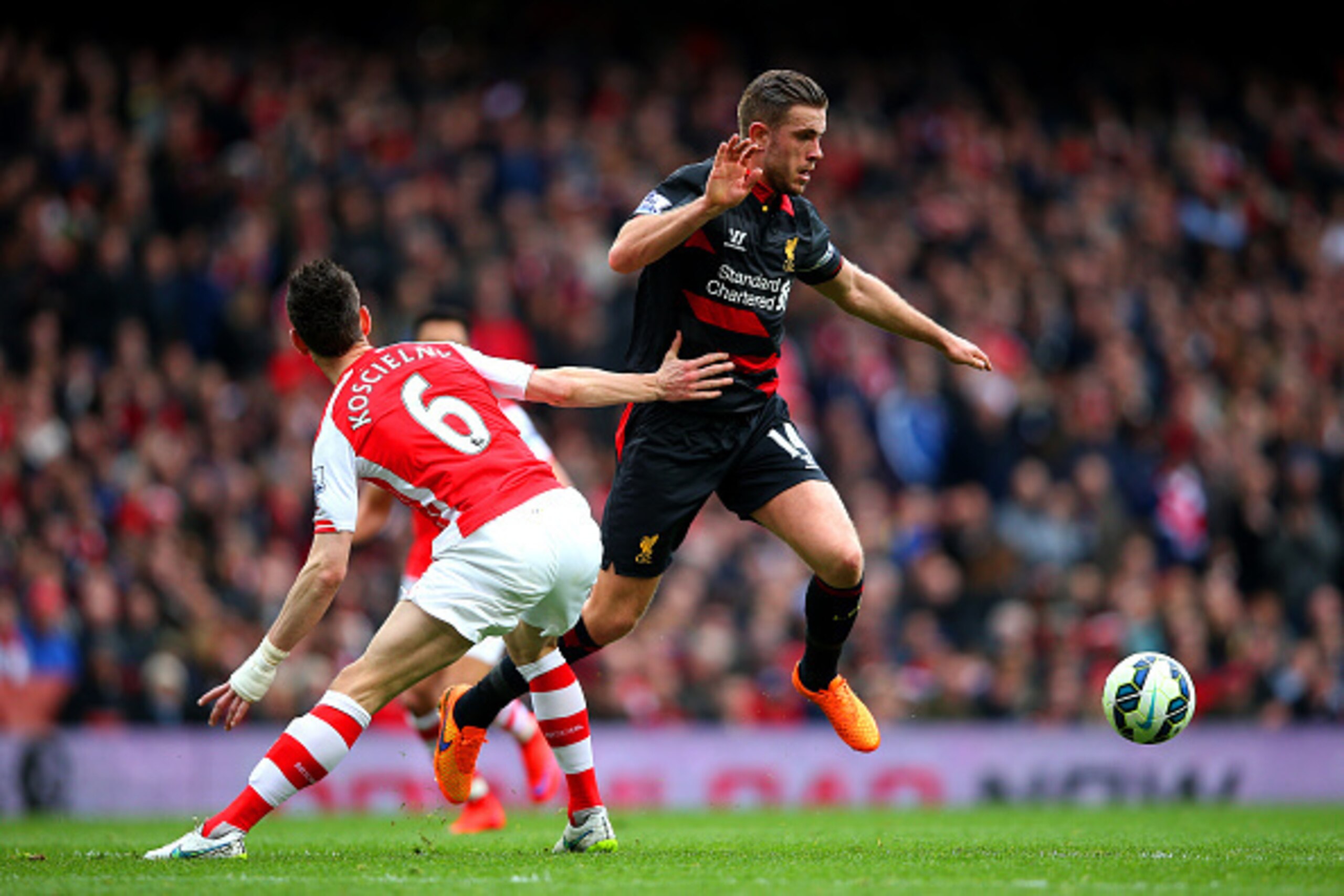 LONDON, ENGLAND - APRIL 04:  Jordan Henderson of Liverpool evades a challenge from Laurent Koscielny of Arsenal during the Barclays Premier League match between Arsenal and Liverpool at Emirates Stadium on April 4, 2015 in London, England.  (Photo by Paul