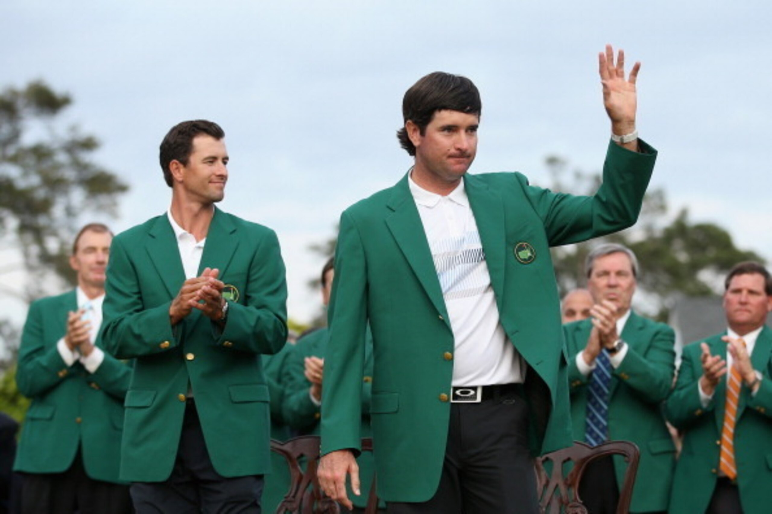 AUGUSTA, GA - APRIL 13:  Adam Scott of Australia presents Bubba Watson of the United States with the green jacket after Watson won the 2014 Masters Tournament by a three-stroke margin at Augusta National Golf Club on April 13, 2014 in Augusta, Georgia.  (