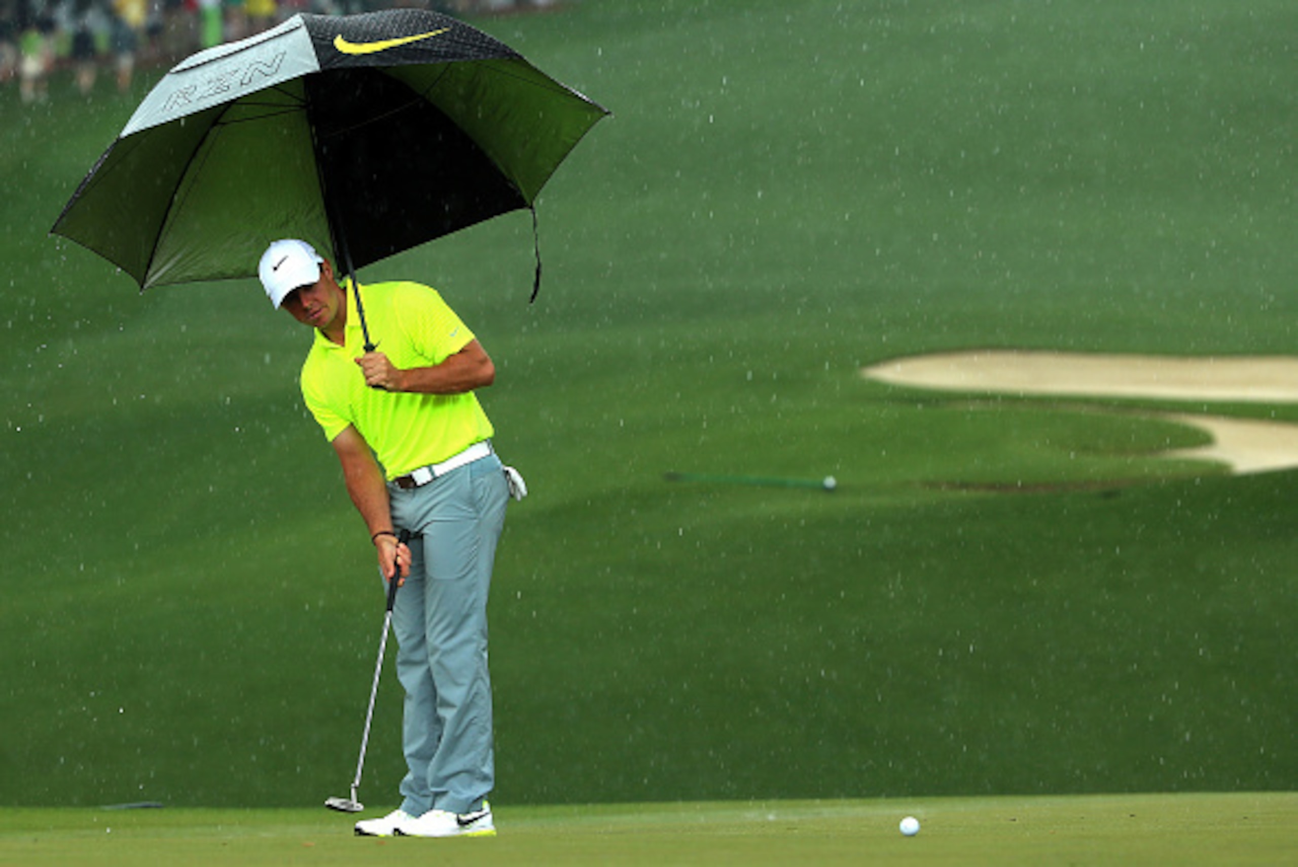 AUGUSTA, GA - APRIL 07:  Rory McIlroy of Northern Ireland hits a putt in the rain during a practice round prior to the start of the 2015 Masters Tournament at Augusta National Golf Club on April 7, 2015 in Augusta, Georgia.  (Photo by Andrew Redington/Get
