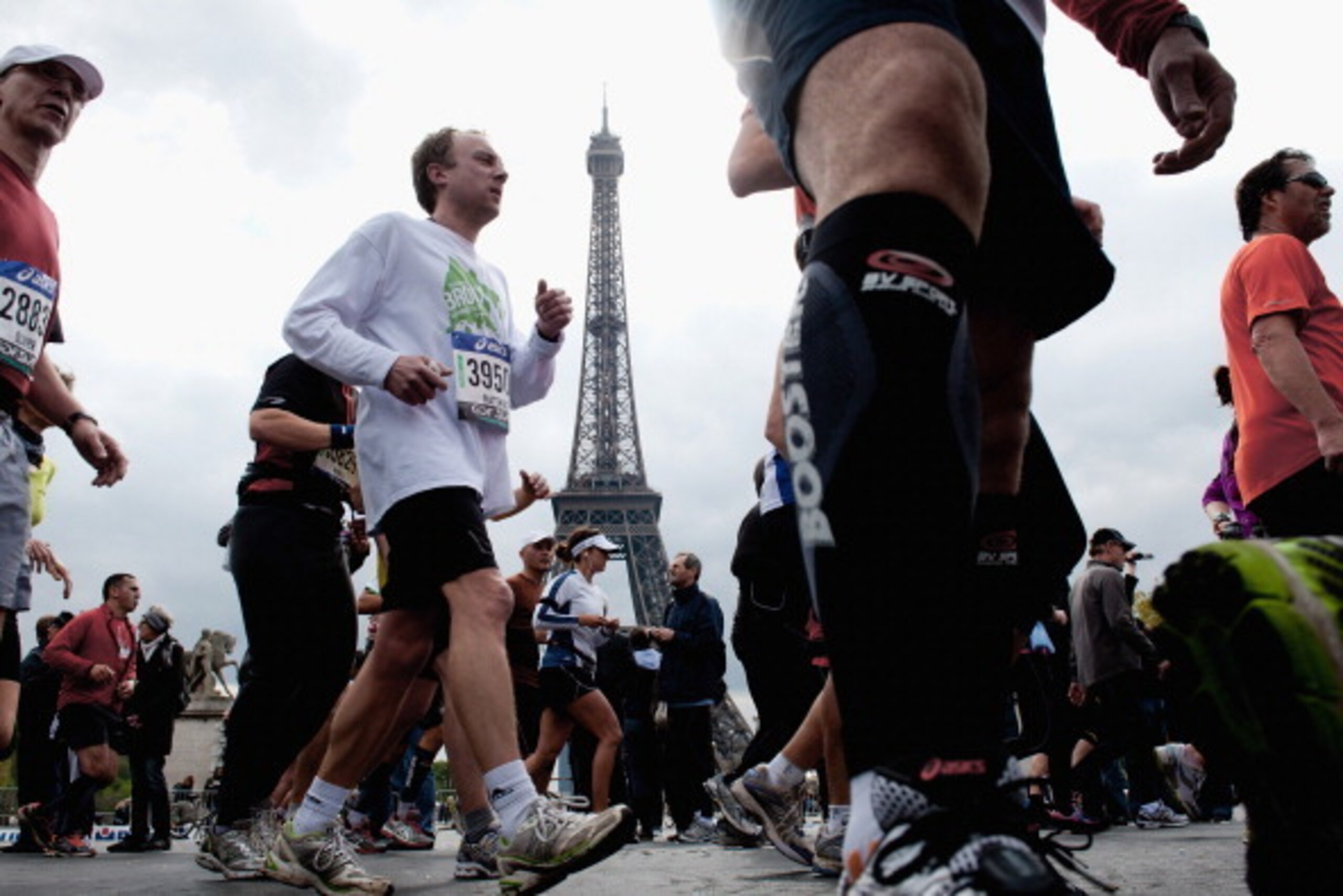 PARIS, FRANCE - APRIL 15:  Competitors run during the 36th Paris Marathon  on April 15, 2012 in Paris, France.  (Photo by Trago/Getty Images)