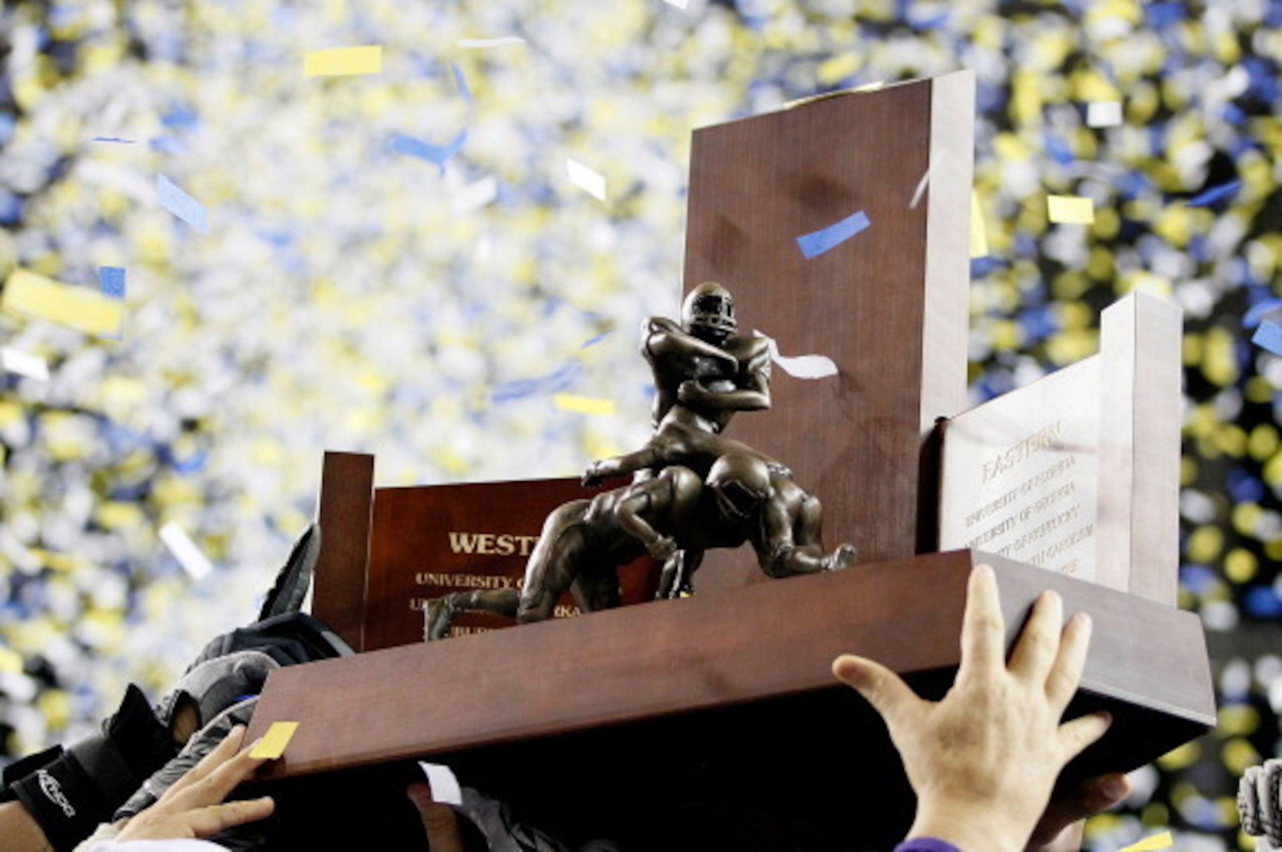 ATLANTA, GA - DECEMBER 03:  The LSU Tigers hold up the 2011 SEC Championship trophy after defeating the Georgia Bulldogs 42-10 at Georgia Dome on December 3, 2011 in Atlanta, Georgia.  (Photo by Kevin C. Cox/Getty Images)
