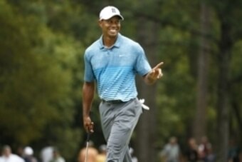 Apr 6, 2015; Augusta, GA, USA; Tiger Woods smiles after making a birdie on the 1st hole during a practice round for The Masters golf tournament at Augusta National Golf Club. Mandatory Credit: Rob Schumacher-USA TODAY Sports
