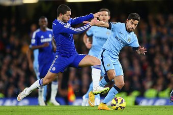 LONDON, ENGLAND - JANUARY 31:  Eden Hazard of Chelsea tackles Jesus Navas of Manchester City during the Barclays Premier League match between Chelsea and Manchester City at Stamford Bridge on January 31, 2015 in London, England.  (Photo by Clive Mason/Get