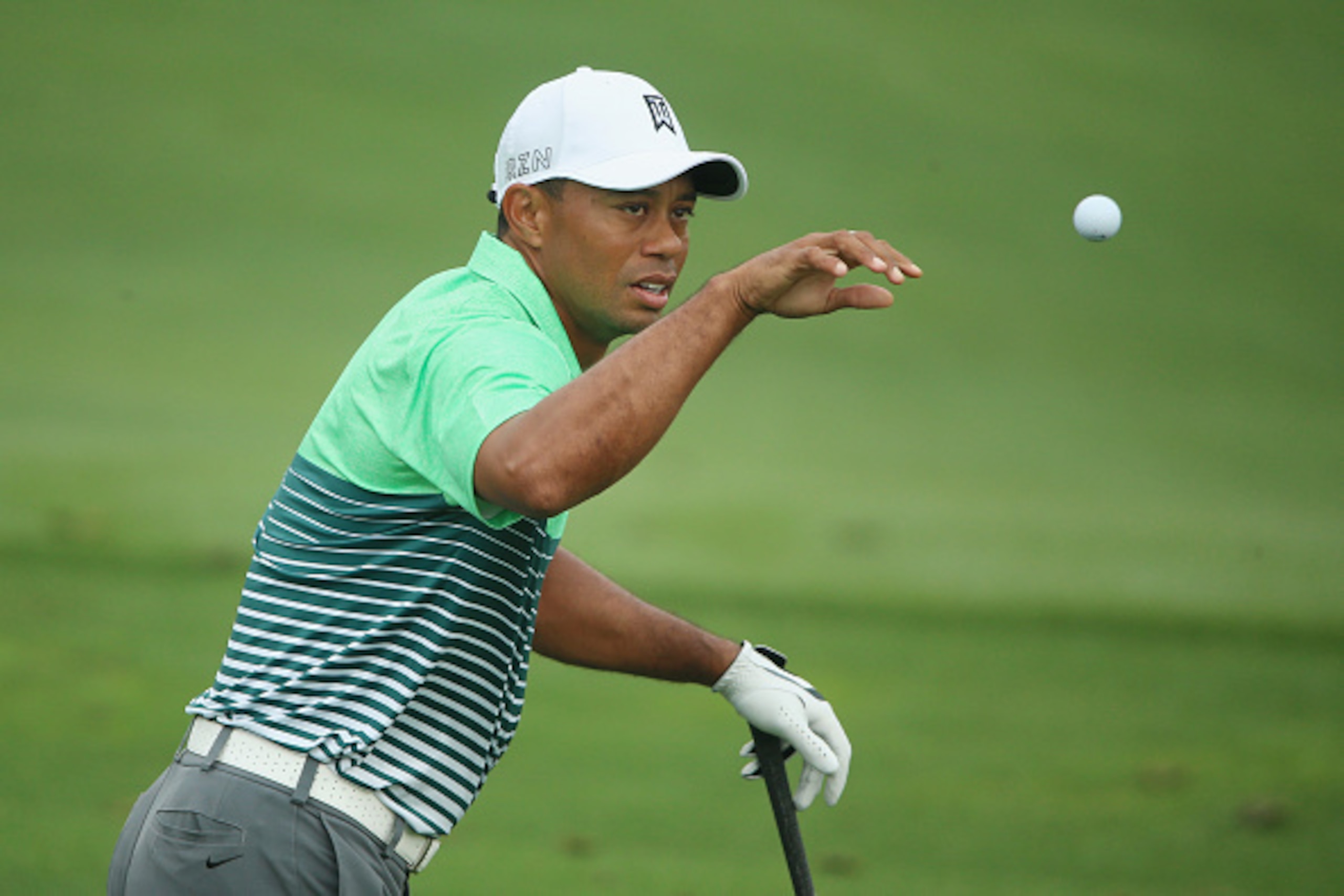 AUGUSTA, GA - APRIL 08:  Tiger Woods of the United States reaches for a golf ball on the practice ground during a practice round prior to the start of the 2015 Masters Tournament at Augusta National Golf Club on April 8, 2015 in Augusta, Georgia.  (Photo 