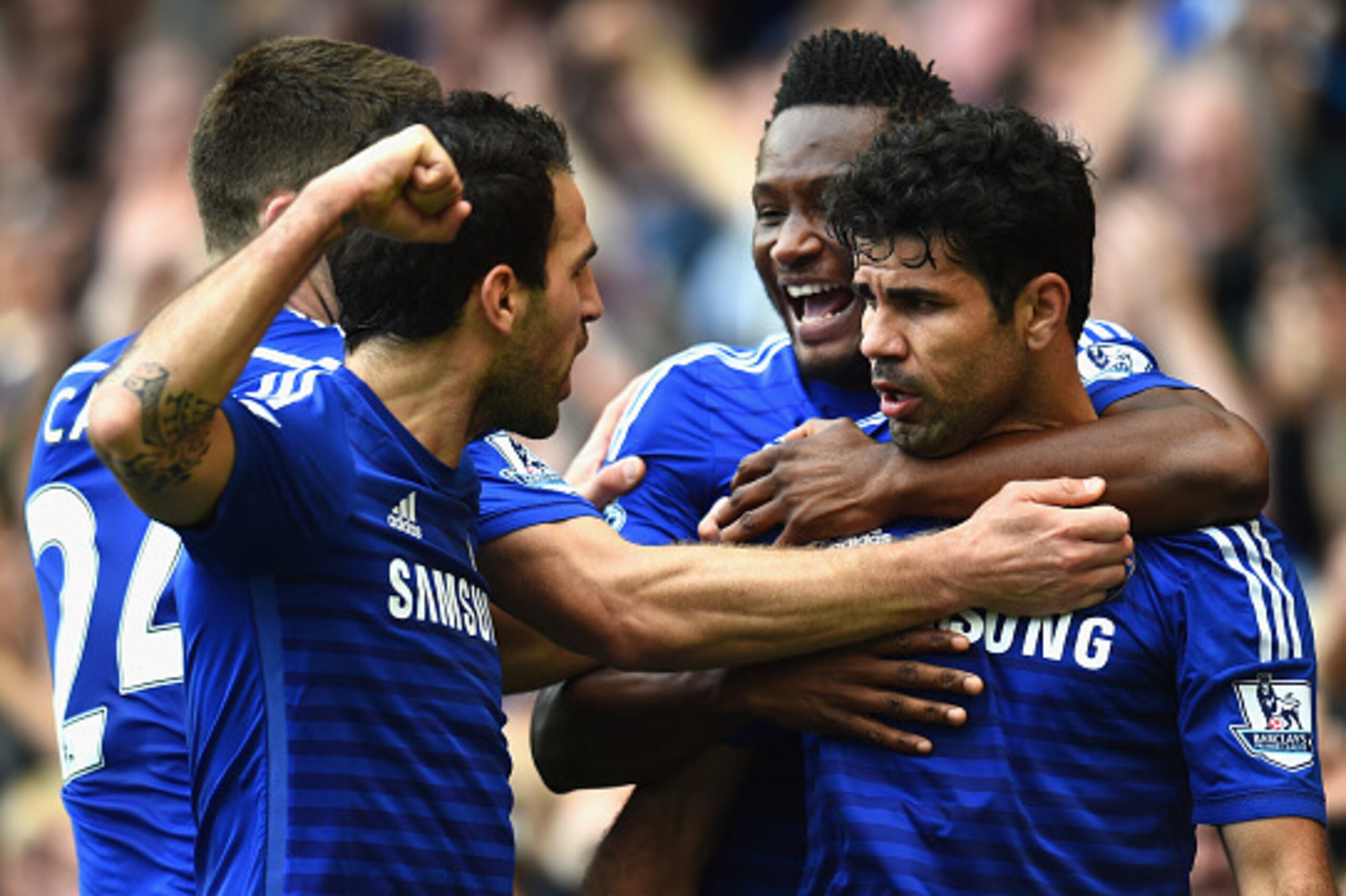 LONDON, ENGLAND - OCTOBER 05:  Diego Costa of Chelsea celebrates scoring their second goal with John Obi Mikel and Cesc Fabregas of Chelsea during the Barclays Premier League match between Chelsea and Arsenal at Stamford Bridge on October 4, 2014 in Londo