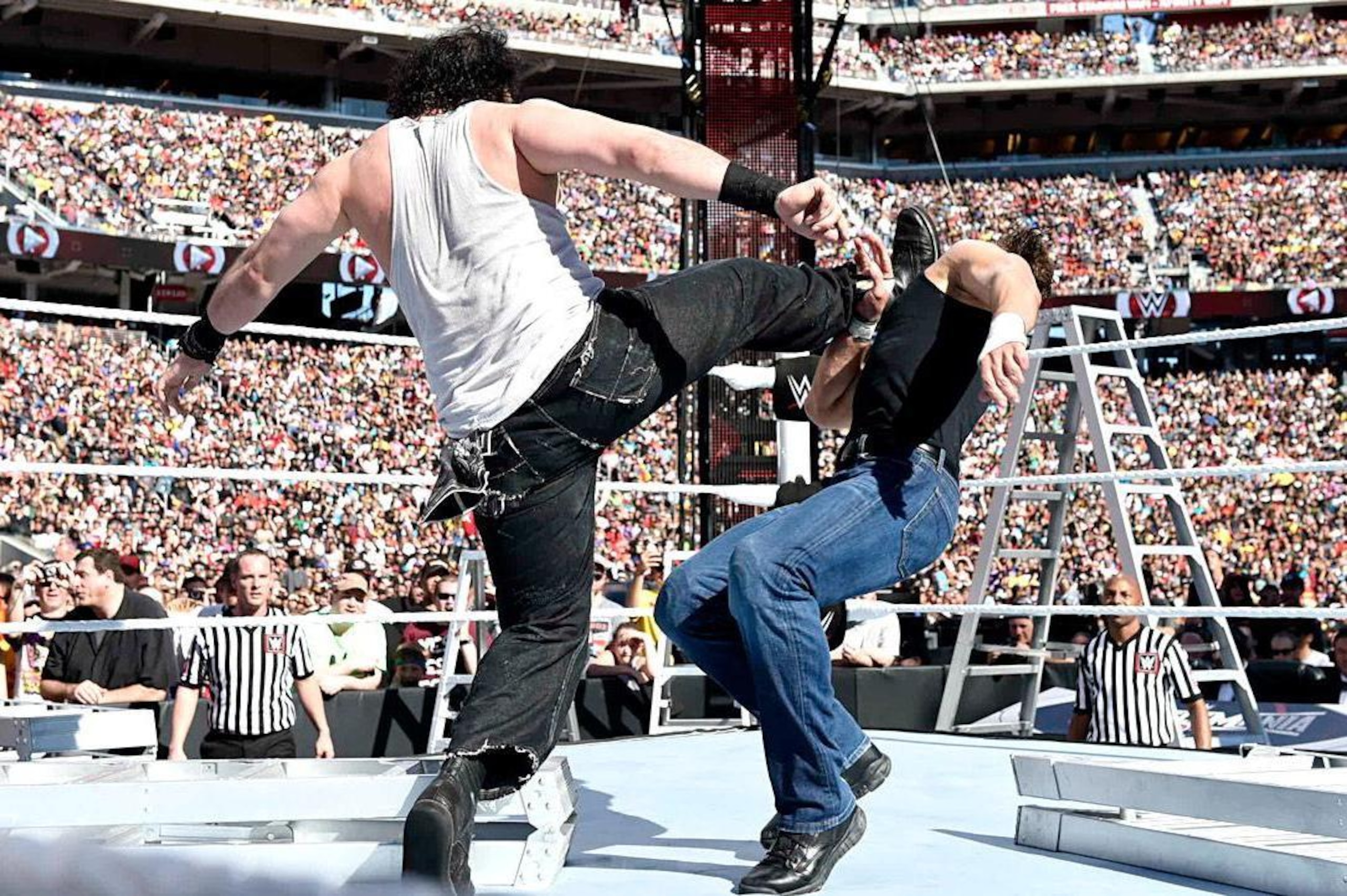 Luke Harper kicks Dean Ambrose. Luke Harper kicks Dean Ambrose.