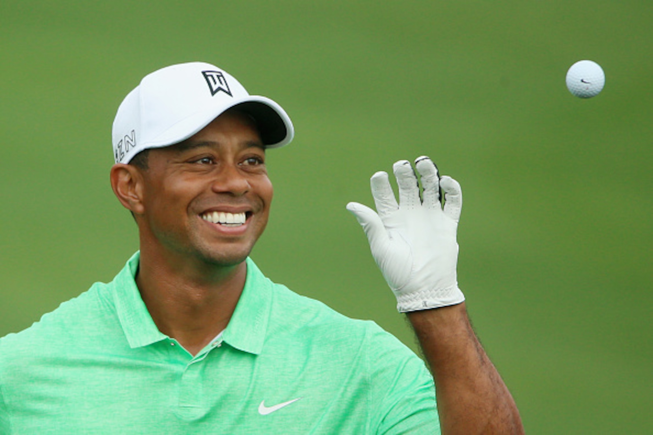 AUGUSTA, GA - APRIL 08:  Tiger Woods of the United States reaches for a golf ball on the practice ground during a practice round prior to the start of the 2015 Masters Tournament at Augusta National Golf Club on April 8, 2015 in Augusta, Georgia.  (Photo 