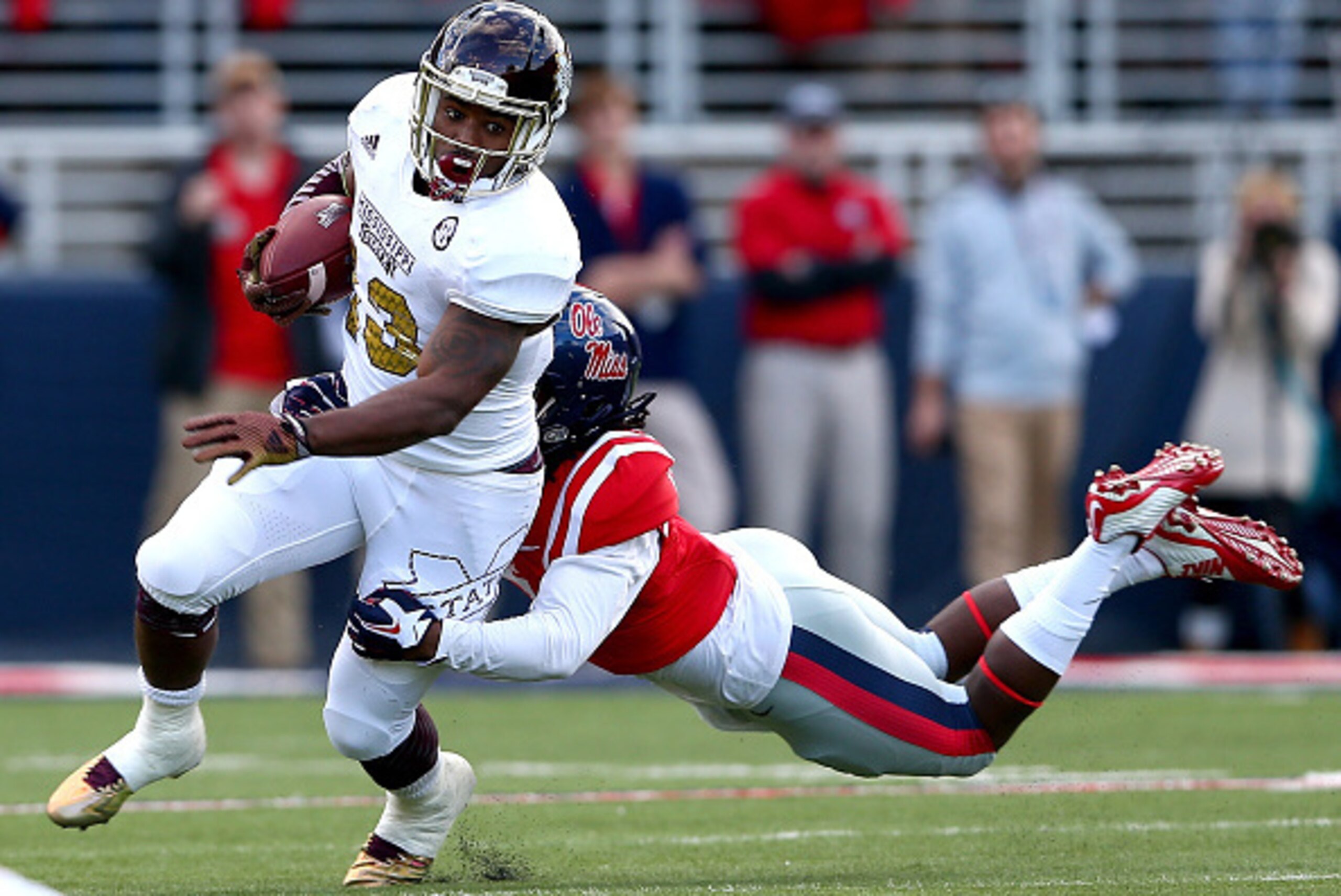 OXFORD, MS - NOVEMBER 29: Josh Robinson #13 of the Mississippi State Bulldogs tries to get away from Mark Dodson #7 of the Mississippi Rebels during their game at Vaught-Hemingway Stadium on November 29, 2014 in Oxford, Mississippi. (Photo by Streeter L OXFORD, MS - NOVEMBER 29: Josh Robinson #13 of the Mississippi State Bulldogs tries to get away from Mark Dodson #7 of the Mississippi Rebels during their game at Vaught-Hemingway Stadium on November 29, 2014 in Oxford, Mississippi. (Photo by Streeter L