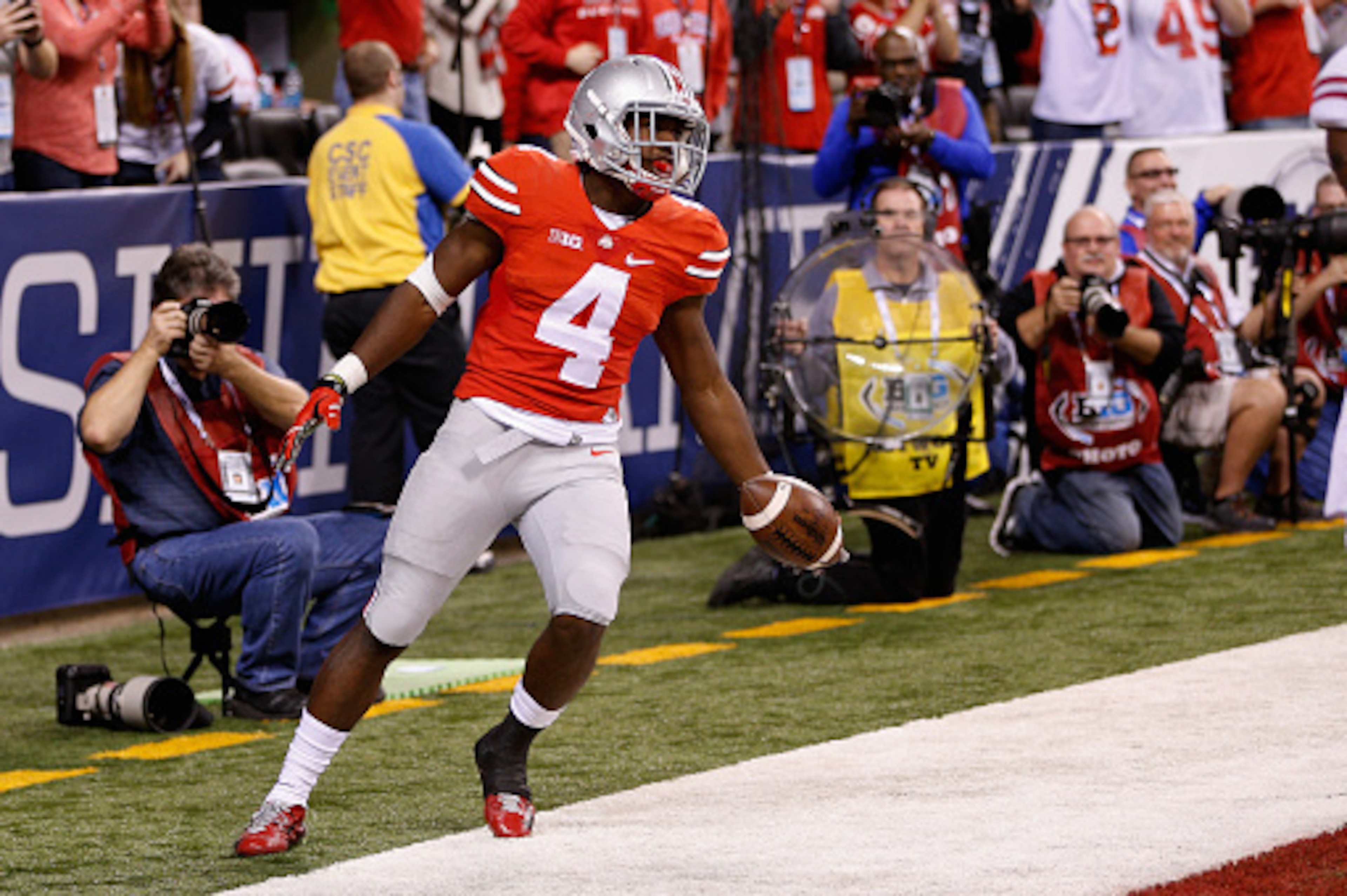 INDIANAPOLIS, IN - DECEMBER 06:  Curtis Samuel #4 of the Ohio State Buckeyes celebrates a touchdown in the fourth quarter against the Wisconsin Badgers in the Big Ten Championship at Lucas Oil Stadium on December 6, 2014 in Indianapolis, Indiana.  The Buc