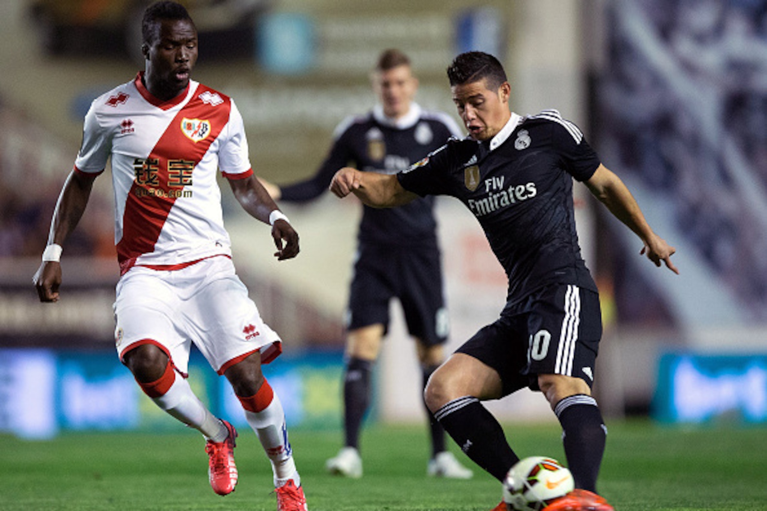 MADRID, SPAIN - APRIL 08: James Rodriguez (R) of Real Madrid CF competes for the ball with Mohammed Fatau (L) of Rayo Vallecano de Madrid during the La Liga match between Rayo Vallecano de Madrid and Real Madrid CF at Vallecas Stadium on April 8, 2015 in MADRID, SPAIN - APRIL 08: James Rodriguez (R) of Real Madrid CF competes for the ball with Mohammed Fatau (L) of Rayo Vallecano de Madrid during the La Liga match between Rayo Vallecano de Madrid and Real Madrid CF at Vallecas Stadium on April 8, 2015 in