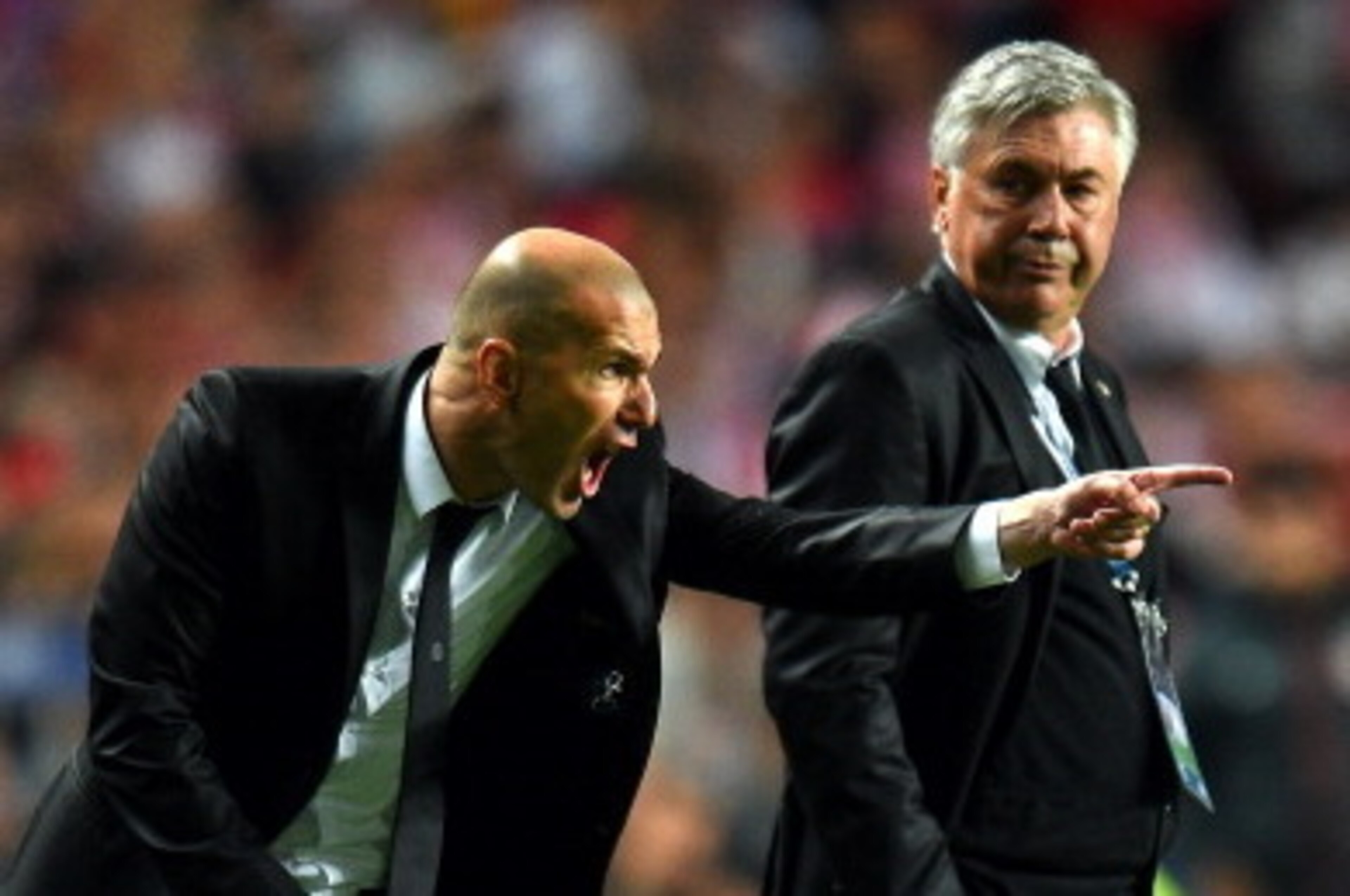 LISBON, PORTUGAL - MAY 24:  Head Coach, Carlo Ancelotti of Real Madrid looks to Assistant coach Zinedine Zidane of Real Madrid as he shouts instructions during the UEFA Champions League Final between Real Madrid and Atletico de Madrid at Estadio da Luz on