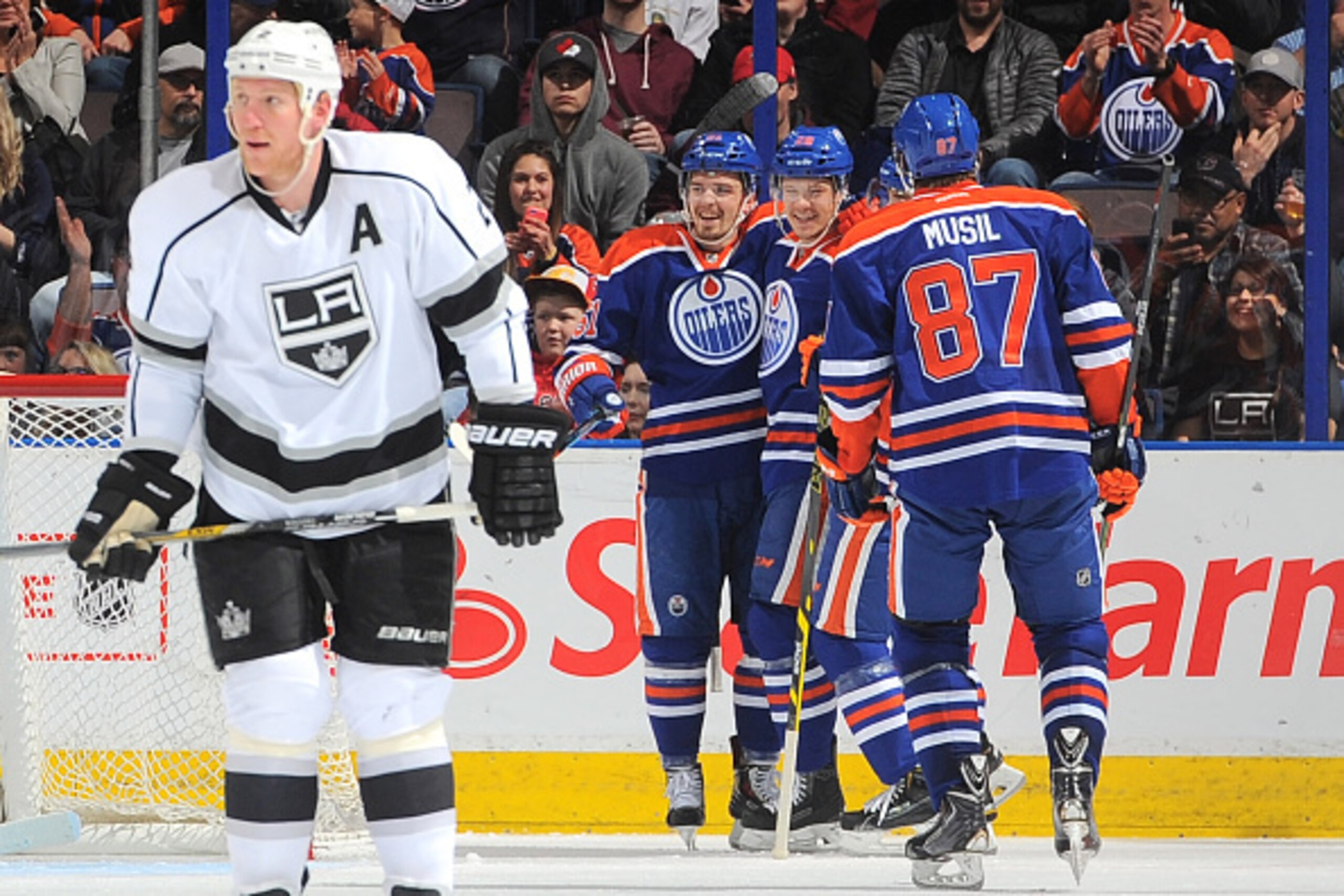 EDMONTON, AB - APRIL 7: David Musil #87, Matt Fraser #28 and Anton Lander #51 of the Edmonton Oilers celebrate after scoring a goal during the game against the Los Angeles Kings on April 7, 2015 at Rexall Place in Edmonton, Alberta, Canada. (Photo by Andy