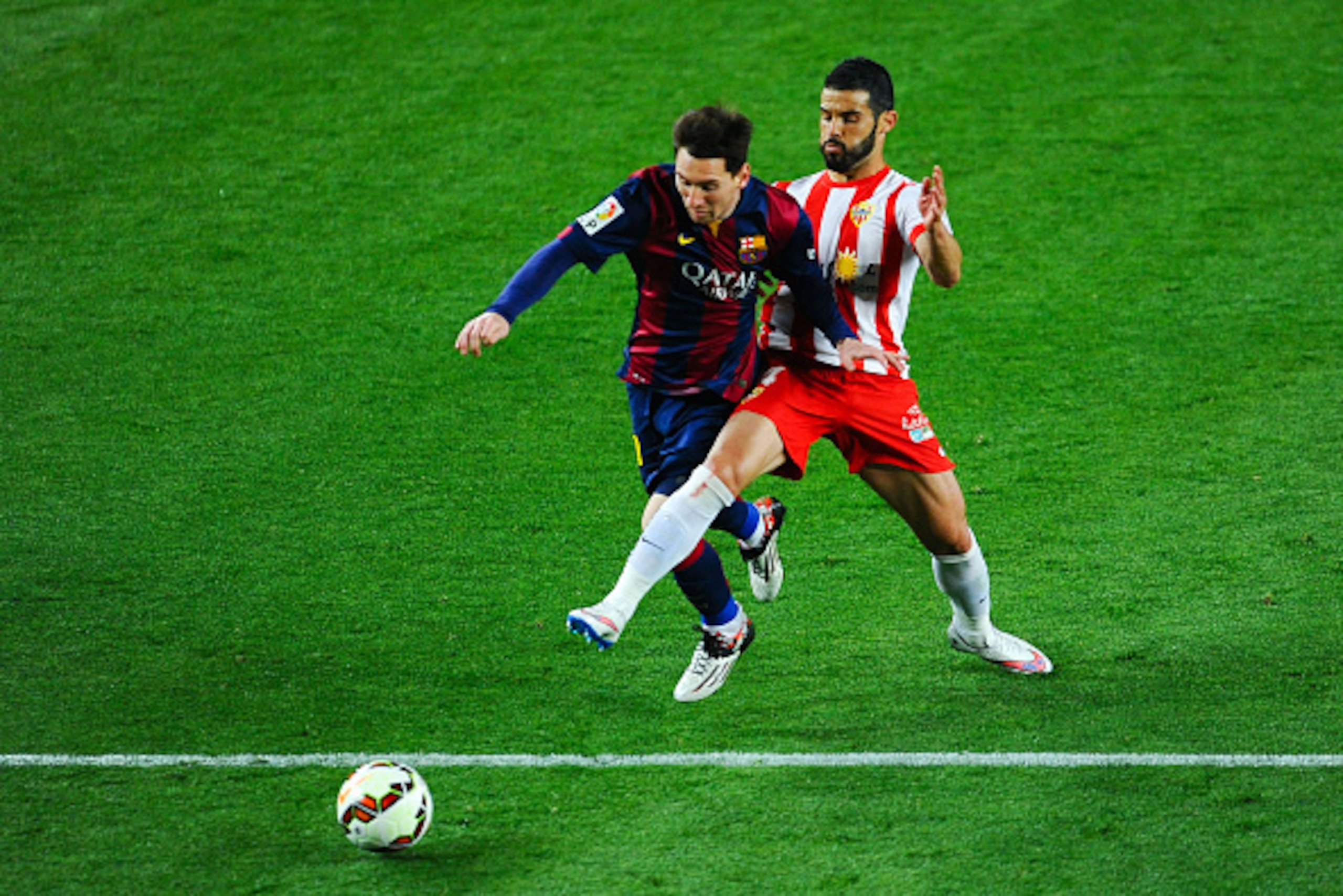 BARCELONA, SPAIN - APRIL 08:  Lionel Messi of FC Barcelona is brought down by Jose Manuel Casado of UD Almeria during the La Liga match between FC Barcelona and UD Almeria at Camp Nou on April 8, 2015 in Barcelona, Spain.  (Photo by David Ramos/Getty Imag