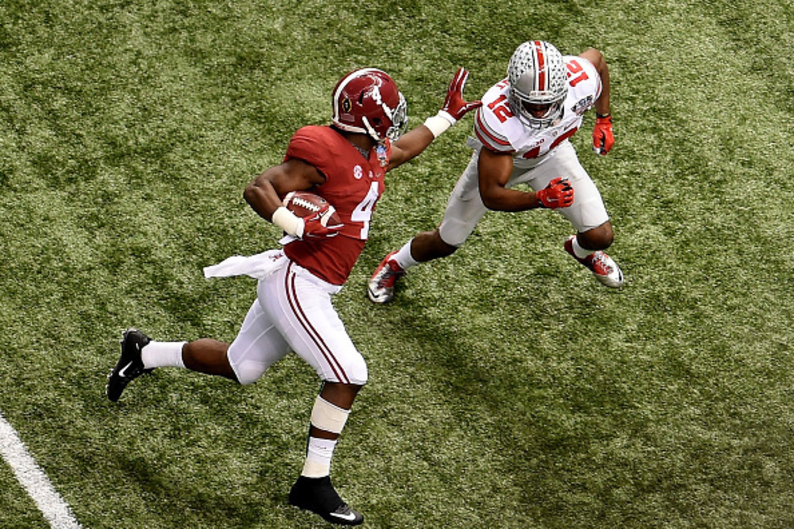 NEW ORLEANS, LA - JANUARY 01:  T.J. Yeldon #4 of the Alabama Crimson Tide runs the ball against Doran Grant #12 of the Ohio State Buckeyes during the All State Sugar Bowl at the Mercedes-Benz Superdome on January 1, 2015 in New Orleans, Louisiana.  (Photo