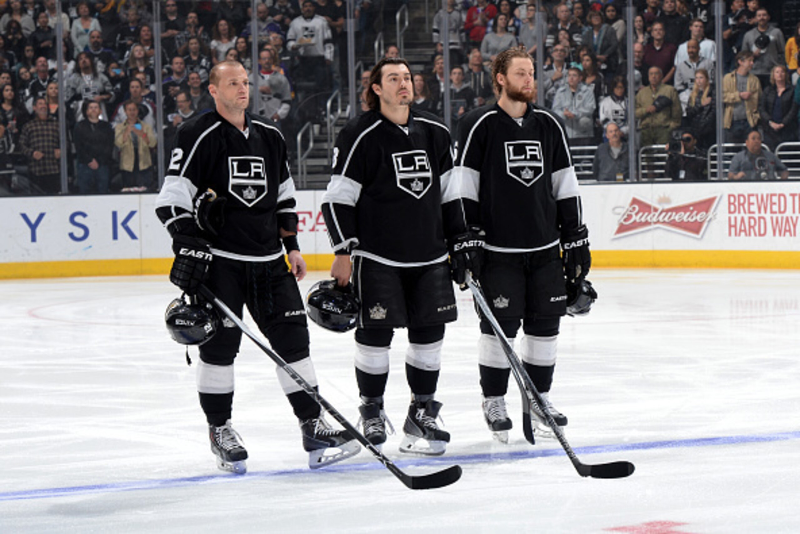 LOS ANGELES, CA - APRIL 4: Marian Gaborik #12, Drew Doughty #8 and Jake Muzzin #6 of the Los Angeles Kings stand in observance of the national anthem before a game against the Colorado Avalanche at STAPLES Center on April 4, 2015 in Los Angeles, Californi