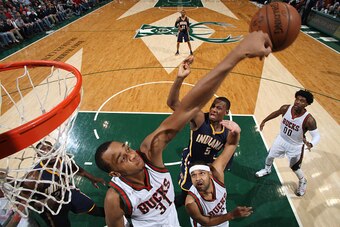 MILWAUKEE, WI - MARCH 26: John Henson #31 of the Milwaukee Bucks blocks a shot against Lavoy Allen #5 of the Indiana Pacers on March 26, 2015 at BMO Harris Bradley Center in Milwaukee, Wisconsin. NOTE TO USER: User expressly acknowledges and agrees that, 