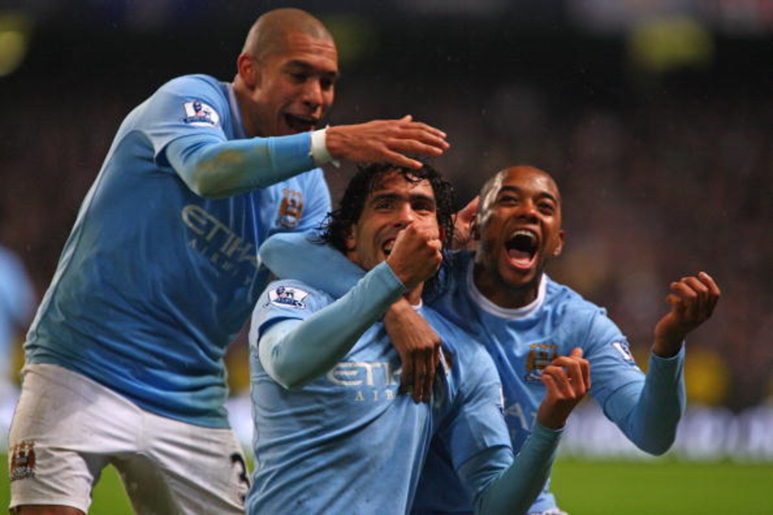 MANCHESTER, ENGLAND - DECEMBER 05:  Carlos Tevez of Manchester City celebrates scoring his team's second goal with team mates Robinho (R) and Nigel de Jong (L) during the Barclays Premier League match between Manchester City and Chelsea at the City of Man