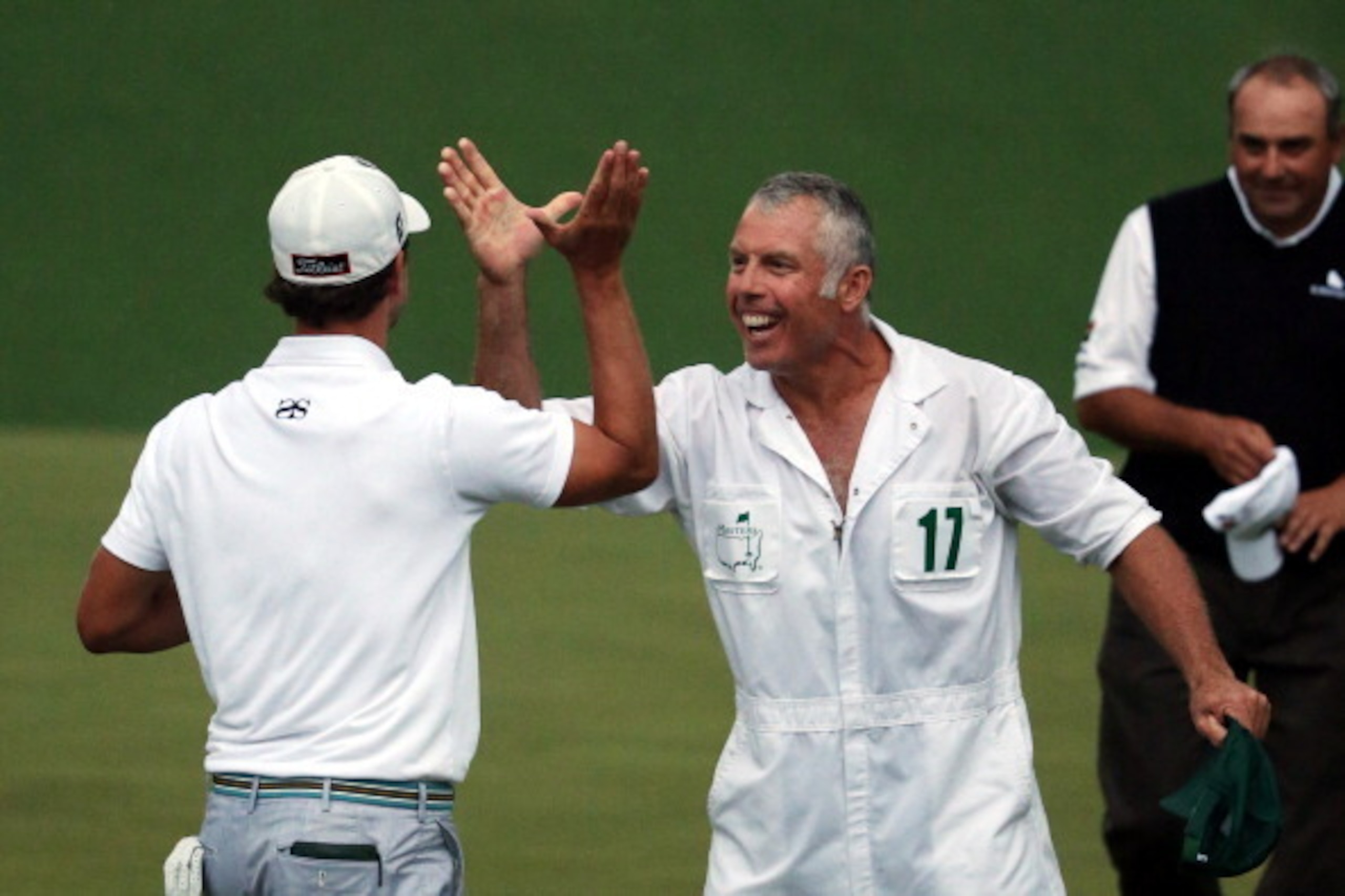 AUGUSTA, GA - APRIL 14:  Adam Scott of Australia reacts alongside caddie Steve Williams after Scott makes a birdie putt on the second sudden death playoff hole to defeat Angel Cabrera of Argentina to win the 2013 Masters Tournament at Augusta National Gol