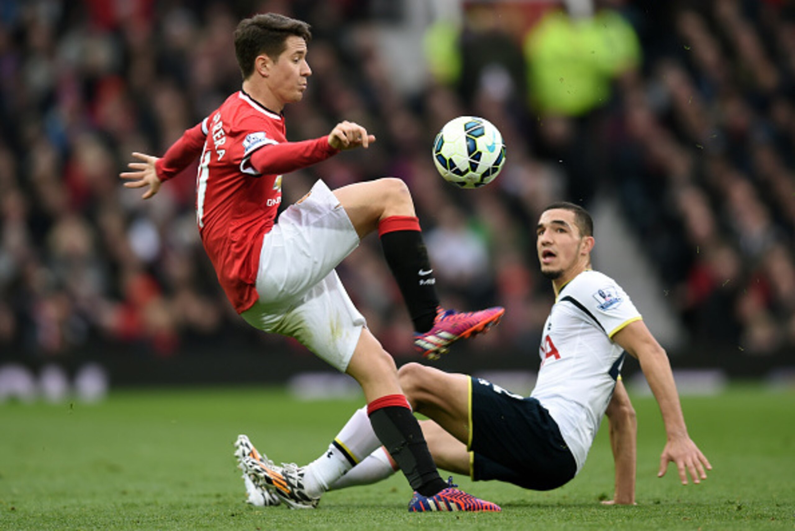 MANCHESTER, ENGLAND - MARCH 15:  Ander Herrera of Manchester United controls the ball as Nabil Bentaleb of Spurs looks on during the Barclays Premier League match between Manchester United and Tottenham Hotspur at Old Trafford on March 15, 2015 in Manches