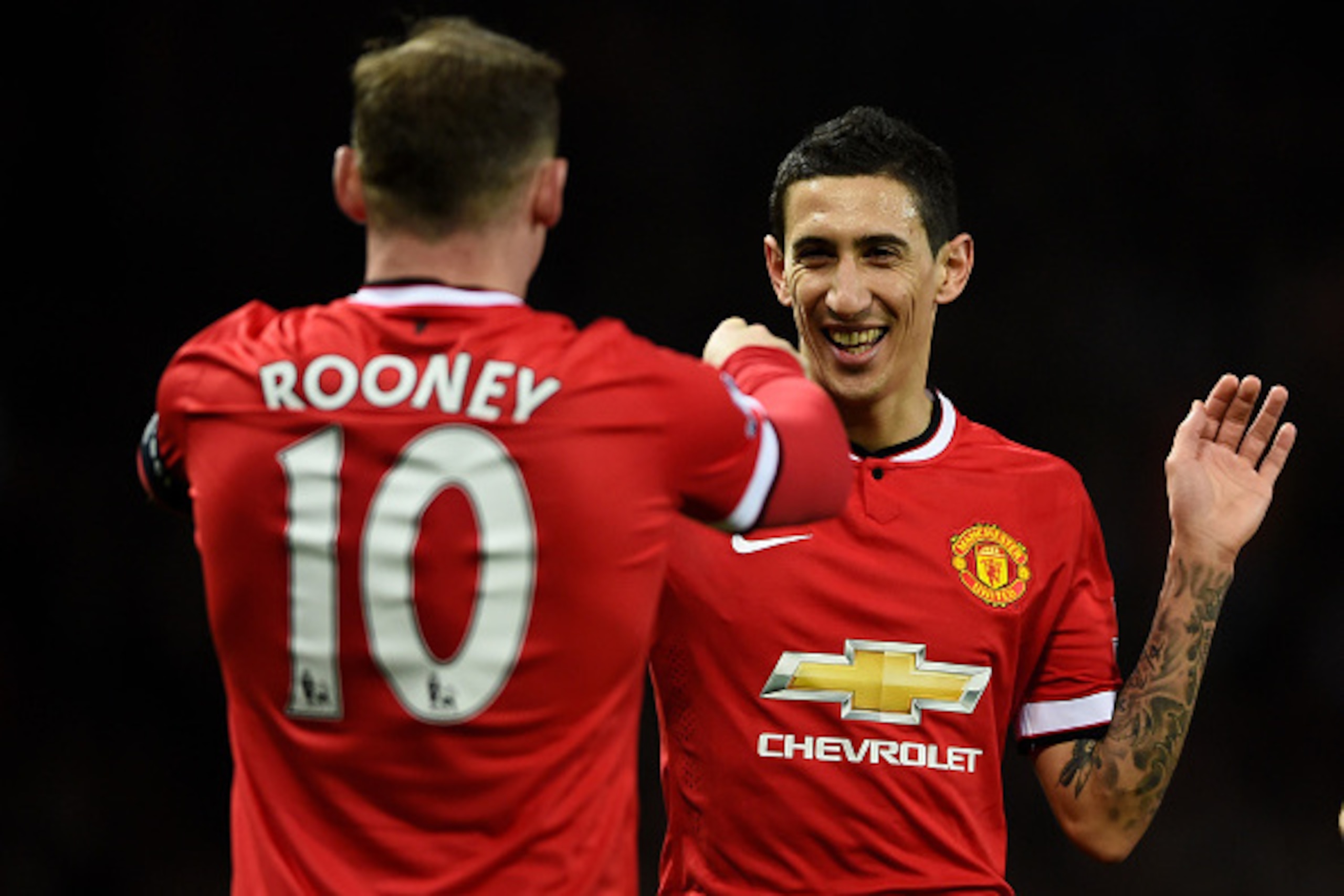 MANCHESTER, ENGLAND - MARCH 09:  Provider of the goal scoring cross Angel di Maria (R) of Manchester United congratultes the scorer Wayne Rooney of Manchester United after the scores are levelled at 1-1 during the FA Cup Quarter Final match between Manche