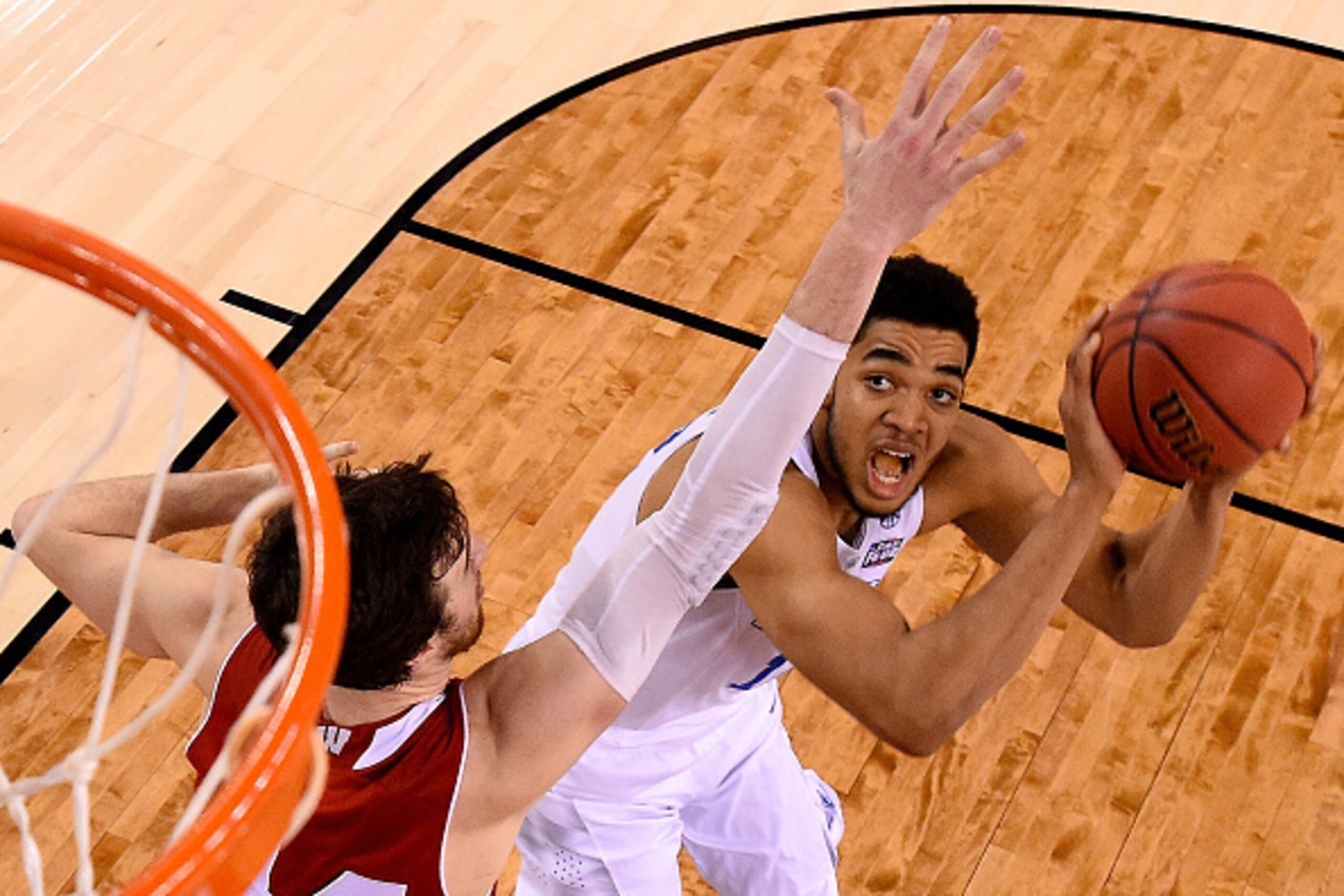 INDIANAPOLIS, IN - APRIL 04: Karl-Anthony Towns #12 of the Kentucky Wildcats looks to shoot against Frank Kaminsky #44 of the Wisconsin Badgers in the second half during the NCAA Men's Final Four Semifinal at Lucas Oil Stadium on April 4, 2015 in Indianap