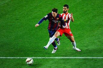 BARCELONA, SPAIN - APRIL 08:  Lionel Messi of FC Barcelona is brought down by Jose Manuel Casado of UD Almeria during the La Liga match between FC Barcelona and UD Almeria at Camp Nou on April 8, 2015 in Barcelona, Spain.  (Photo by David Ramos/Getty Imag