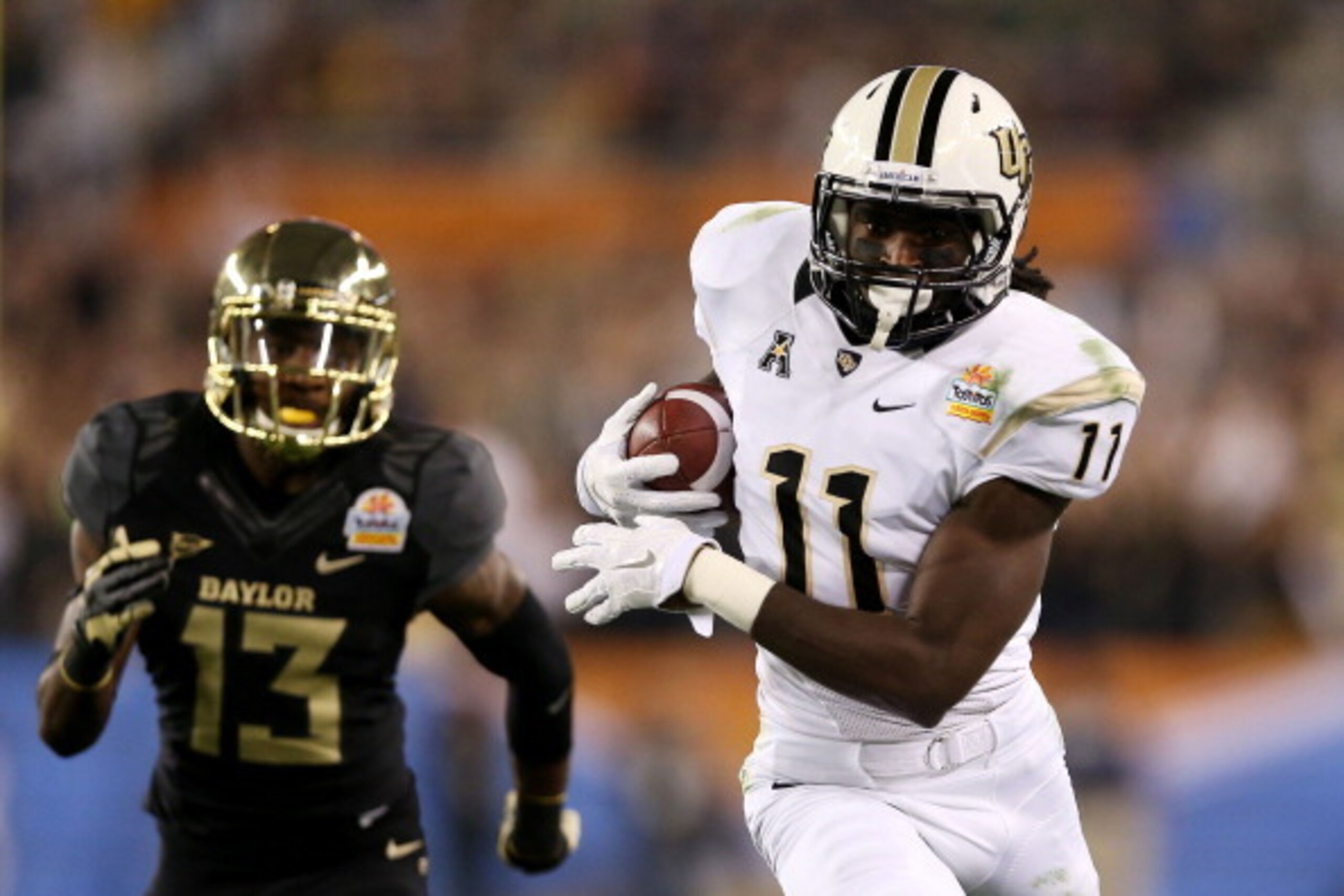 GLENDALE, AZ - JANUARY 01:  Breshad Perriman #11 of the UCF Knights completes a pass for 44 yards in the first quarter against the defense of Terrell Burt #13 of the Baylor Bears during the Tostitos Fiesta Bowl at University of Phoenix Stadium on January 