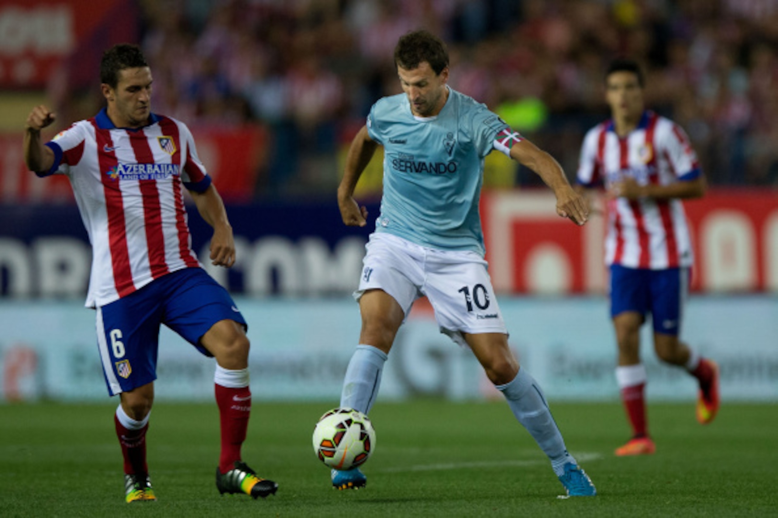 MADRID, SPAIN - AUGUST 30: Captain Mikel Arruabarrena (R) Arambide of SD Eibar competes for the ball with Koke L) of Atletico de Madrid during the La Liga match between Club Atletico de Madrid and SD Eibar at Vicente Calderon Stadium on August 30, 2014 in