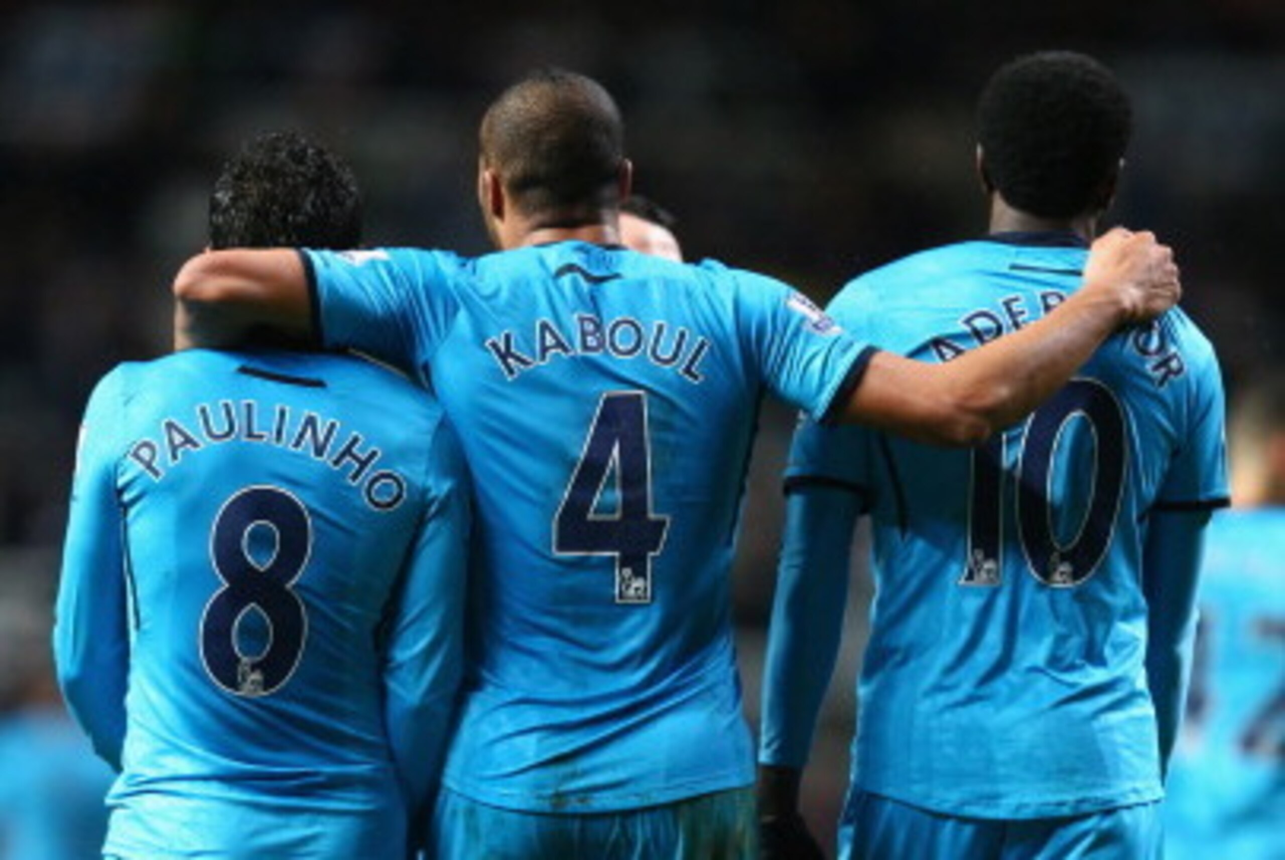 NEWCASTLE UPON TYNE, ENGLAND - FEBRUARY 12:  Emmanuel Adebayor (R) of Tottenham Hotspur celebrates scoring his sides third goal with Younes Kaboul (C) and Paulinho (L) during the Barclays Premier League match between Newcastle United and Tottenham Hotspur