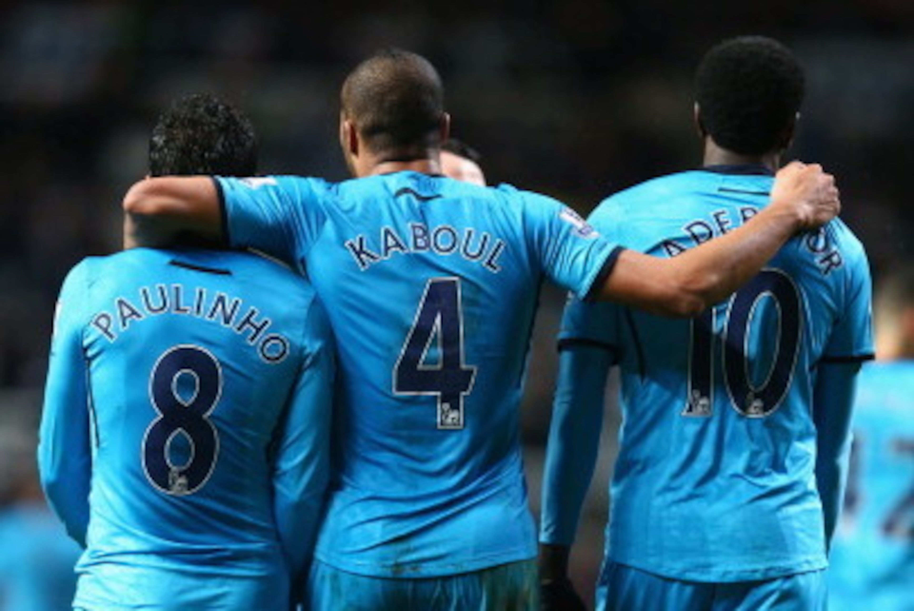 NEWCASTLE UPON TYNE, ENGLAND - FEBRUARY 12:  Emmanuel Adebayor (R) of Tottenham Hotspur celebrates scoring his sides third goal with Younes Kaboul (C) and Paulinho (L) during the Barclays Premier League match between Newcastle United and Tottenham Hotspur