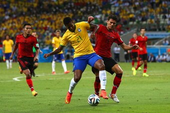 FORTALEZA, BRAZIL - JUNE 17: Jo of Brazil is challenged by Hector Moreno of Mexico during the 2014 FIFA World Cup Brazil Group A match between Brazil and Mexico at Castelao on June 17, 2014 in Fortaleza, Brazil.  (Photo by Michael Steele/Getty Images)