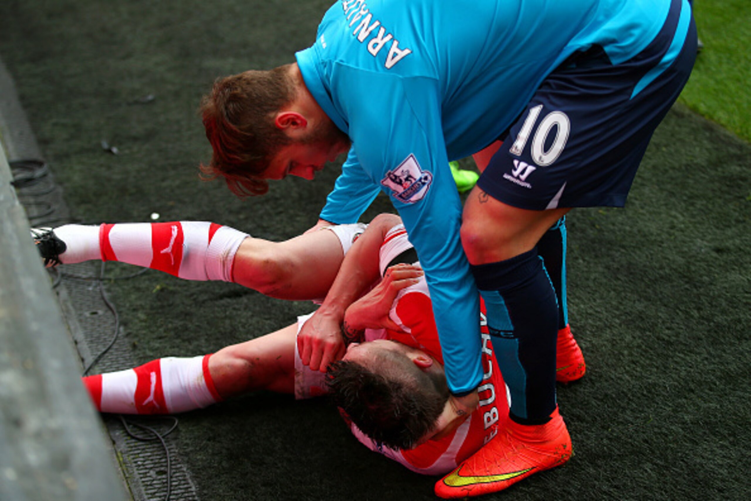 LONDON, ENGLAND - JANUARY 11: Marko Arnautovic of Stoke City checks on Mathieu Debuchy of Arsenal after they clashed during a challenge for the ball resulting in Debuchy's injury during the Barclays Premier League match between Arsenal and Stoke City at LONDON, ENGLAND - JANUARY 11: Marko Arnautovic of Stoke City checks on Mathieu Debuchy of Arsenal after they clashed during a challenge for the ball resulting in Debuchy's injury during the Barclays Premier League match between Arsenal and Stoke City at