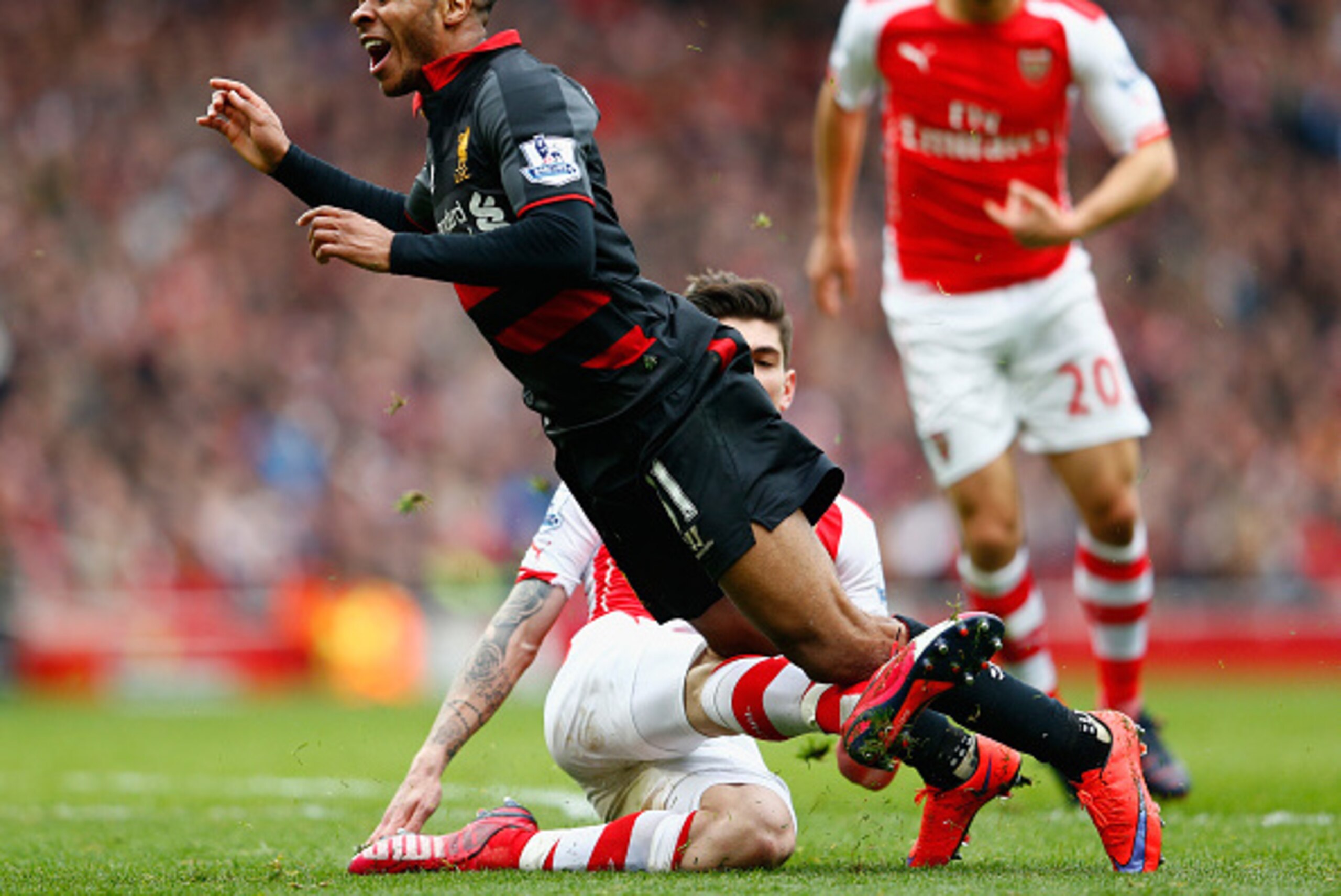 LONDON, ENGLAND - APRIL 04: Raheem Sterling of Liverpool is fouled by Hector Bellerin of Arsenal
to concede a penalty during the Barclays Premier League match between Arsenal and Liverpool at the Emirates Stadium on April 4, 2015 in London, England. (Ph LONDON, ENGLAND - APRIL 04: Raheem Sterling of Liverpool is fouled by Hector Bellerin of Arsenal
to concede a penalty during the Barclays Premier League match between Arsenal and Liverpool at the Emirates Stadium on April 4, 2015 in London, England. (Ph