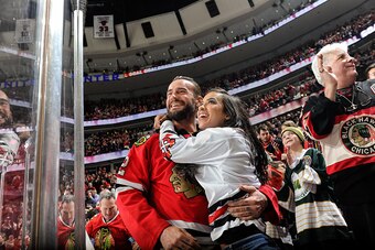CHICAGO, IL - FEBRUARY 13:  MMA fighter and former WWE champion, CM Punk, and wife WWE wrestler AJ Lee, celebrate after the Chicago Blackhawks scored against the New Jersey Devils in the third period during the NHL game at the United Center on February 13