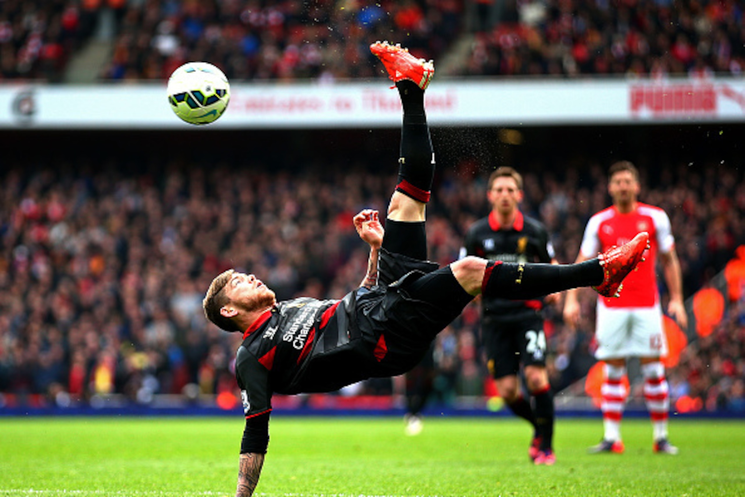 LONDON, ENGLAND - APRIL 04:  Alberto Moreno of Liverpool attempts an overhead kick during the Barclays Premier League match between Arsenal and Liverpool at Emirates Stadium on April 4, 2015 in London, England.  (Photo by Paul Gilham/Getty Images)
