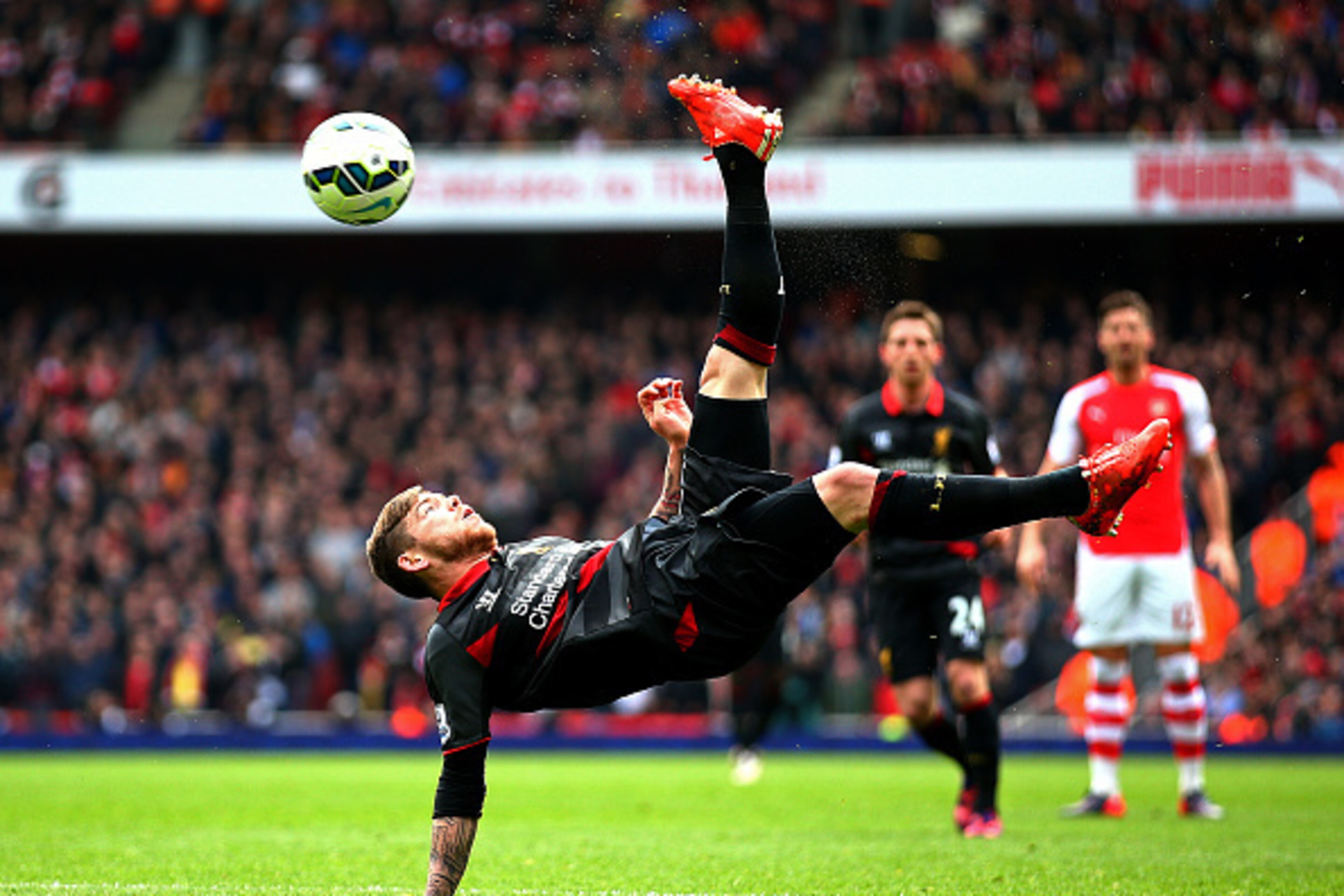 LONDON, ENGLAND - APRIL 04: Alberto Moreno of Liverpool attempts an overhead kick during the Barclays Premier League match between Arsenal and Liverpool at Emirates Stadium on April 4, 2015 in London, England. (Photo by Paul Gilham/Getty Images) LONDON, ENGLAND - APRIL 04: Alberto Moreno of Liverpool attempts an overhead kick during the Barclays Premier League match between Arsenal and Liverpool at Emirates Stadium on April 4, 2015 in London, England. (Photo by Paul Gilham/Getty Images)