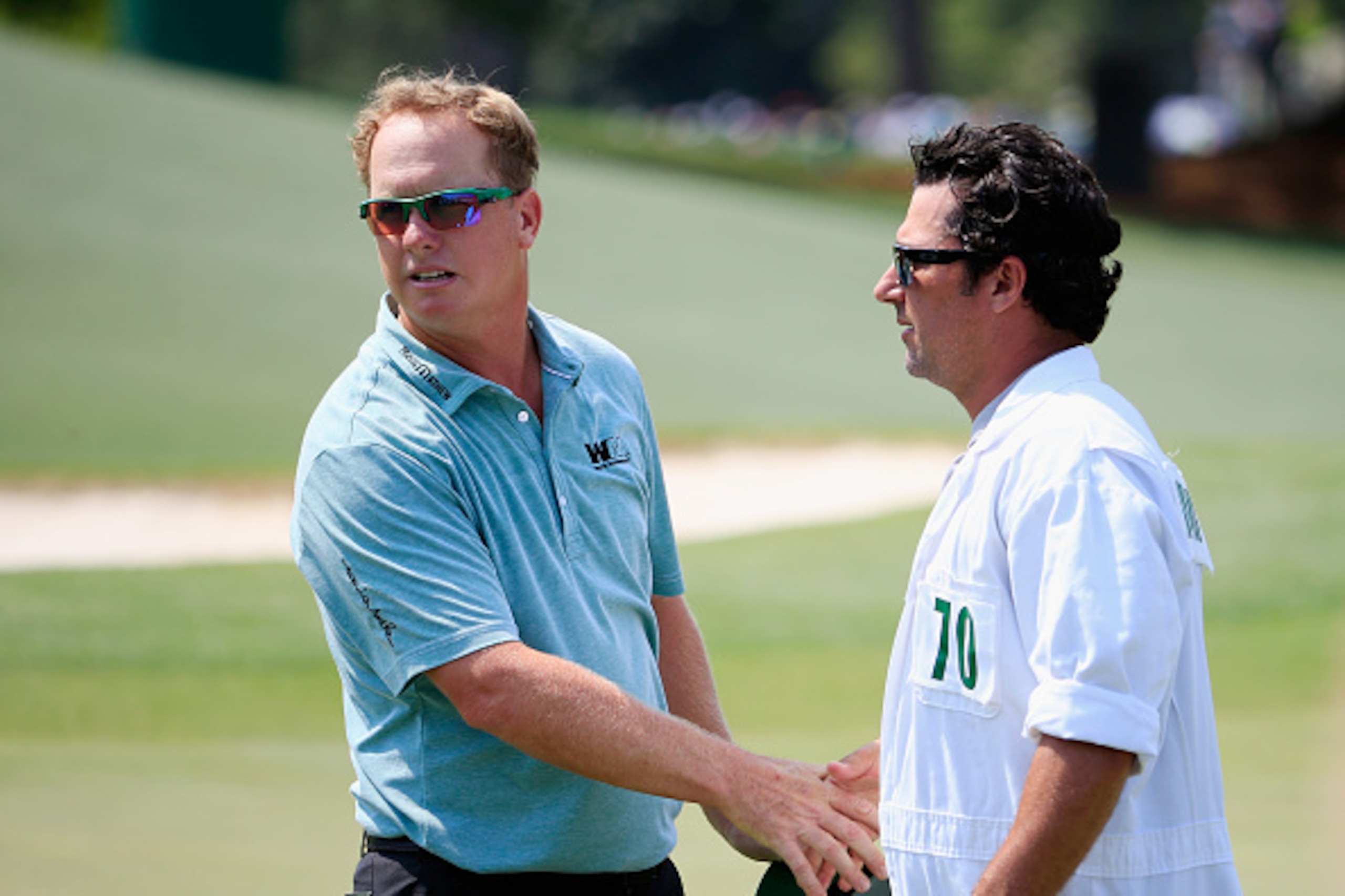 AUGUSTA, GA - APRIL 09:  Charley Hoffman of the United States shakes hands with his caddie Brett Waldman on the 18th green after finishing with a five-under par 67 during the first round of the 2015 Masters Tournament at Augusta National Golf Club on Apri