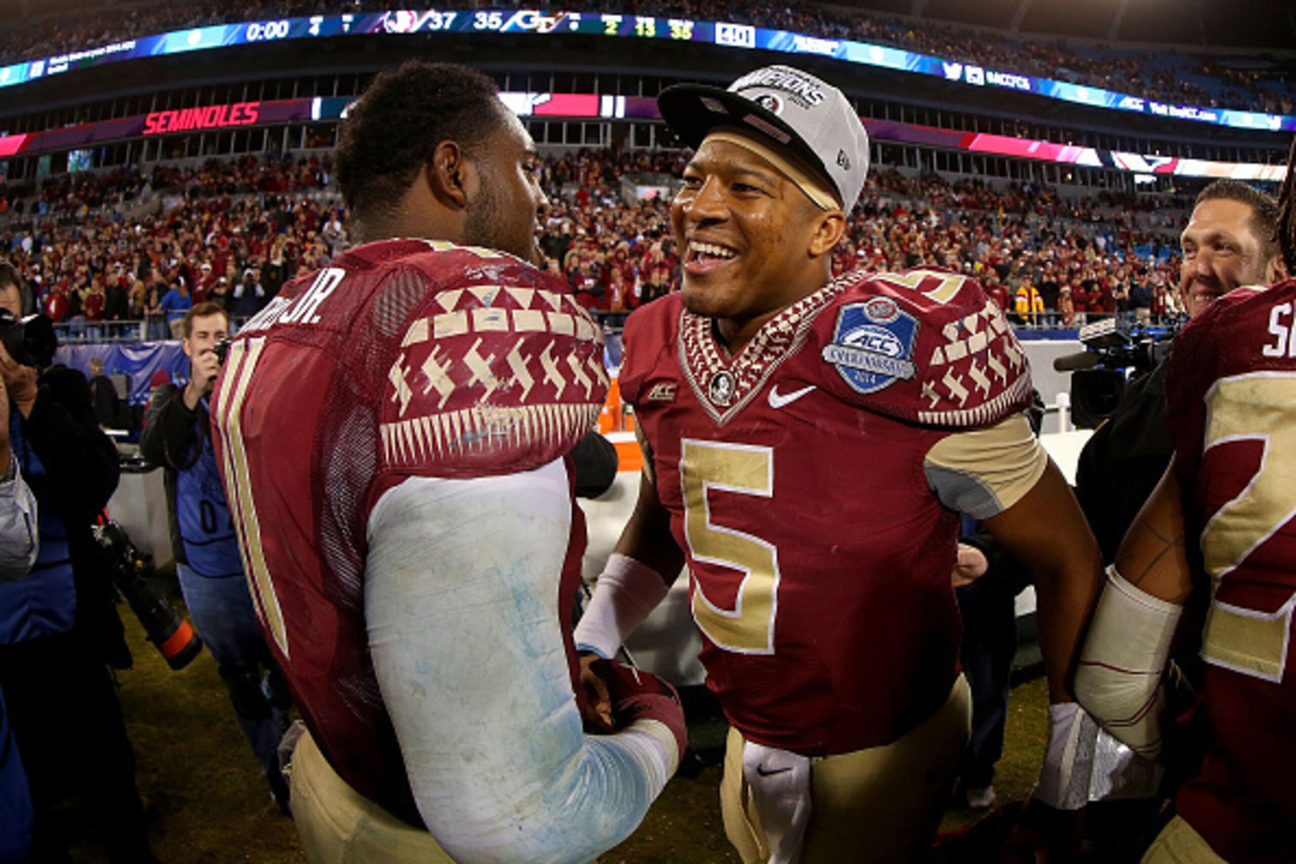 CHARLOTTE, NC - DECEMBER 06:  Jameis Winston #5 and John Franklin III #11 of the Florida State Seminoles of the Florida State Seminoles congratulate each other after their 37-35 victory over the Georgia Tech Yellow Jackets at the ACC Championship game on 