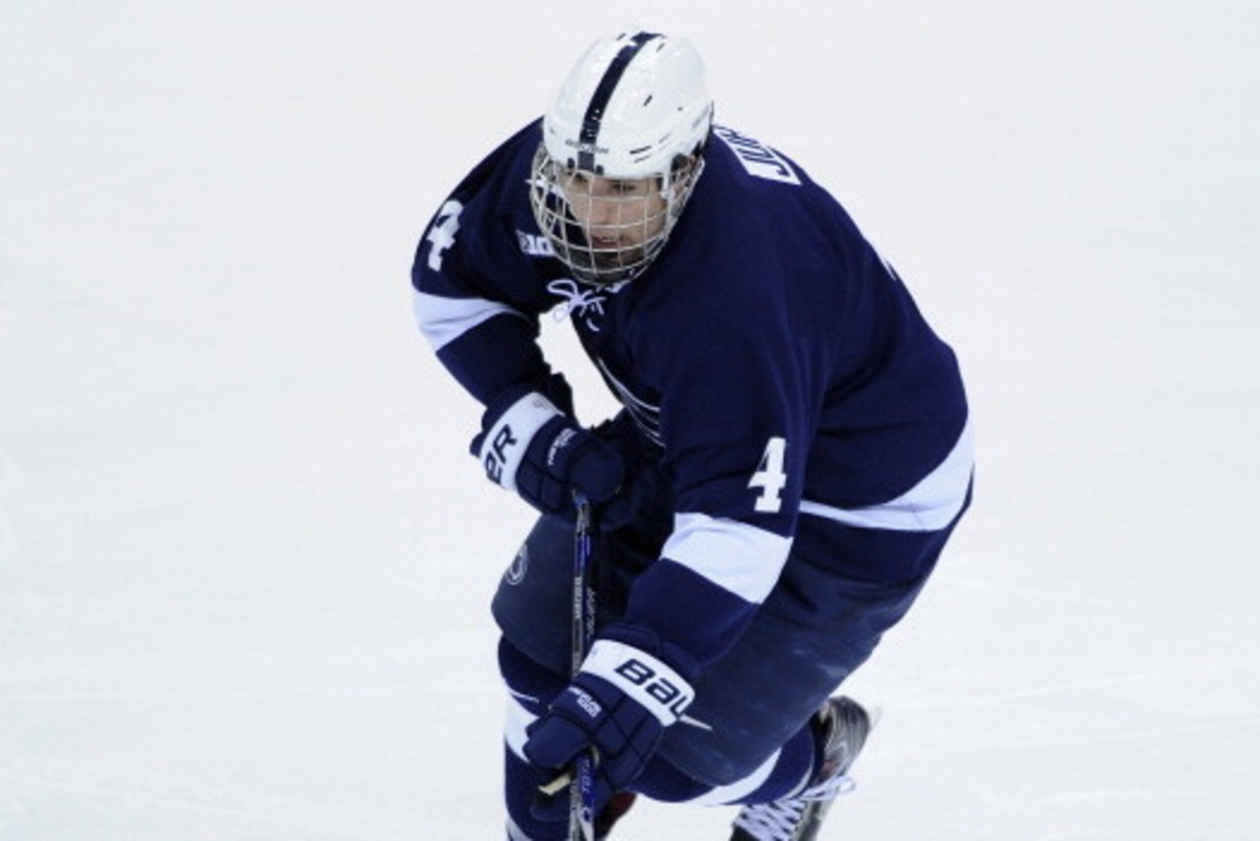 ST PAUL, MN - MARCH 21: Luke Juha #4 of the Penn State Nittany Lions controls the puck during the third period of the semifinal game of the Big Ten Men's Ice Hockey Championship against the Wisconsin Badgers on March 21, 2014 at Xcel Energy Center in St P