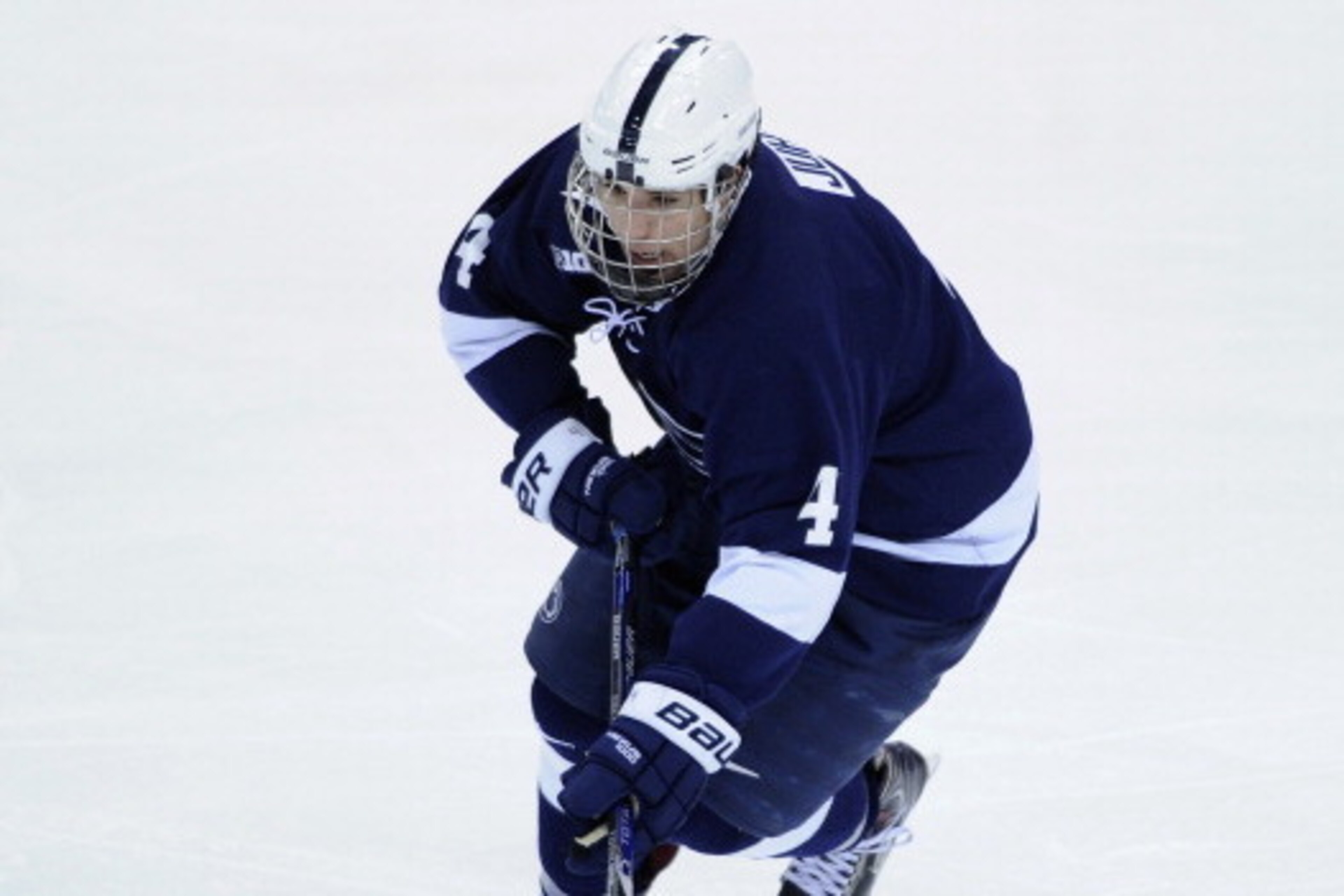 ST PAUL, MN - MARCH 21: Luke Juha #4 of the Penn State Nittany Lions controls the puck during the third period of the semifinal game of the Big Ten Men's Ice Hockey Championship against the Wisconsin Badgers on March 21, 2014 at Xcel Energy Center in St P