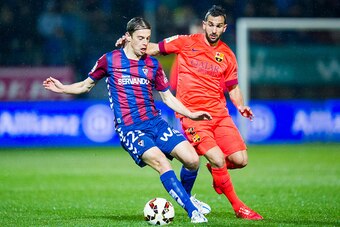 EIBAR, SPAIN - MARCH 14:  Martin Montoya of FC Barcelona duels for the ball with Javier Lara of SD Eibar during the La Liga match between SD Eibar and FC Barcelona at Ipurua Municipal Stadium on March 14, 2015 in Eibar, Spain.  (Photo by Juan Manuel Serra