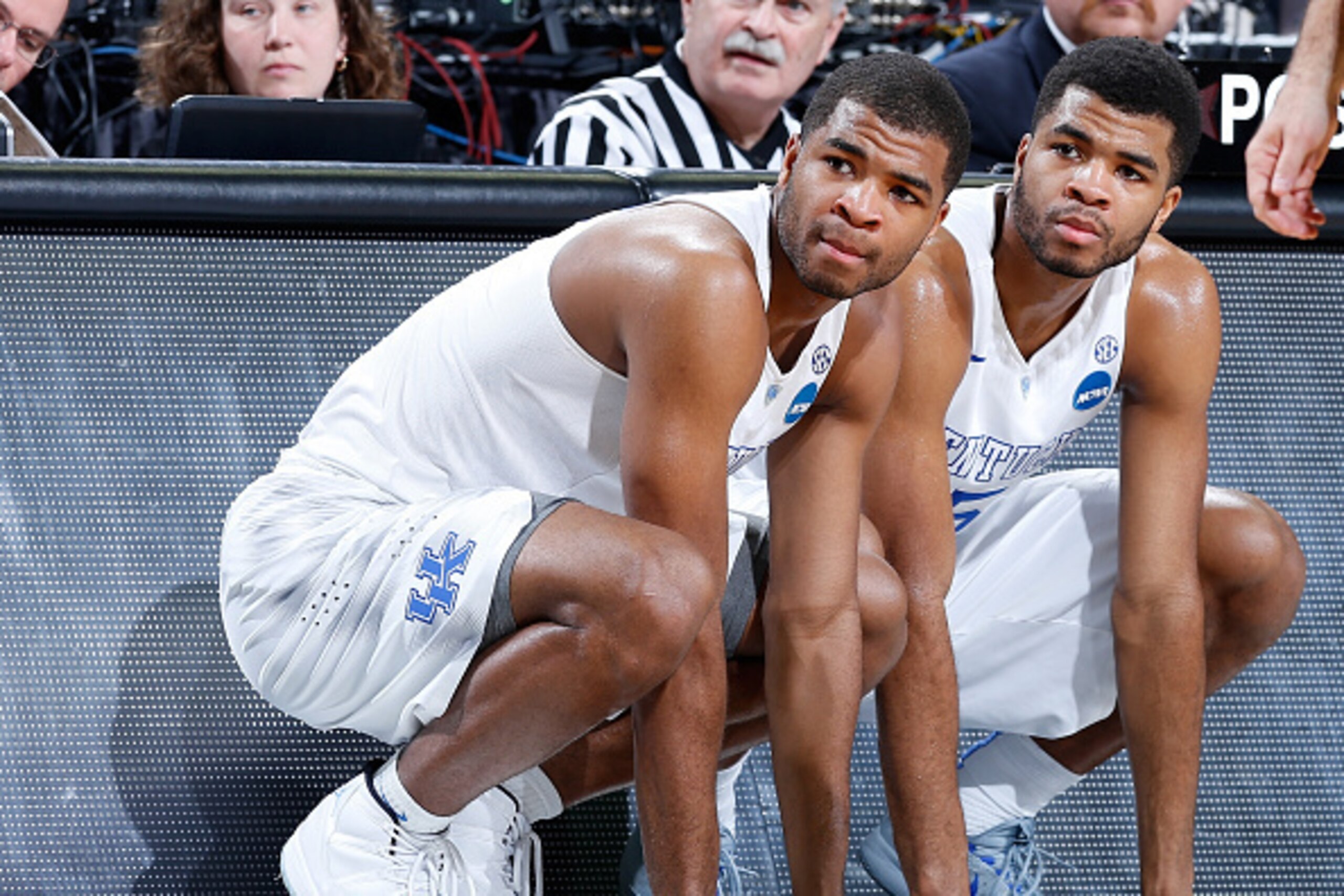 LOUISVILLE, KY - MARCH 21:  (L-R)Teammates and brothers, Aaron Harrison #2 and Andrew Harrison #5 of the Kentucky Wildcats, wait to go in the game against the Cincinnati Bearcats during the third round of the 2015 NCAA Men's Basketball Tournament at KFC Y