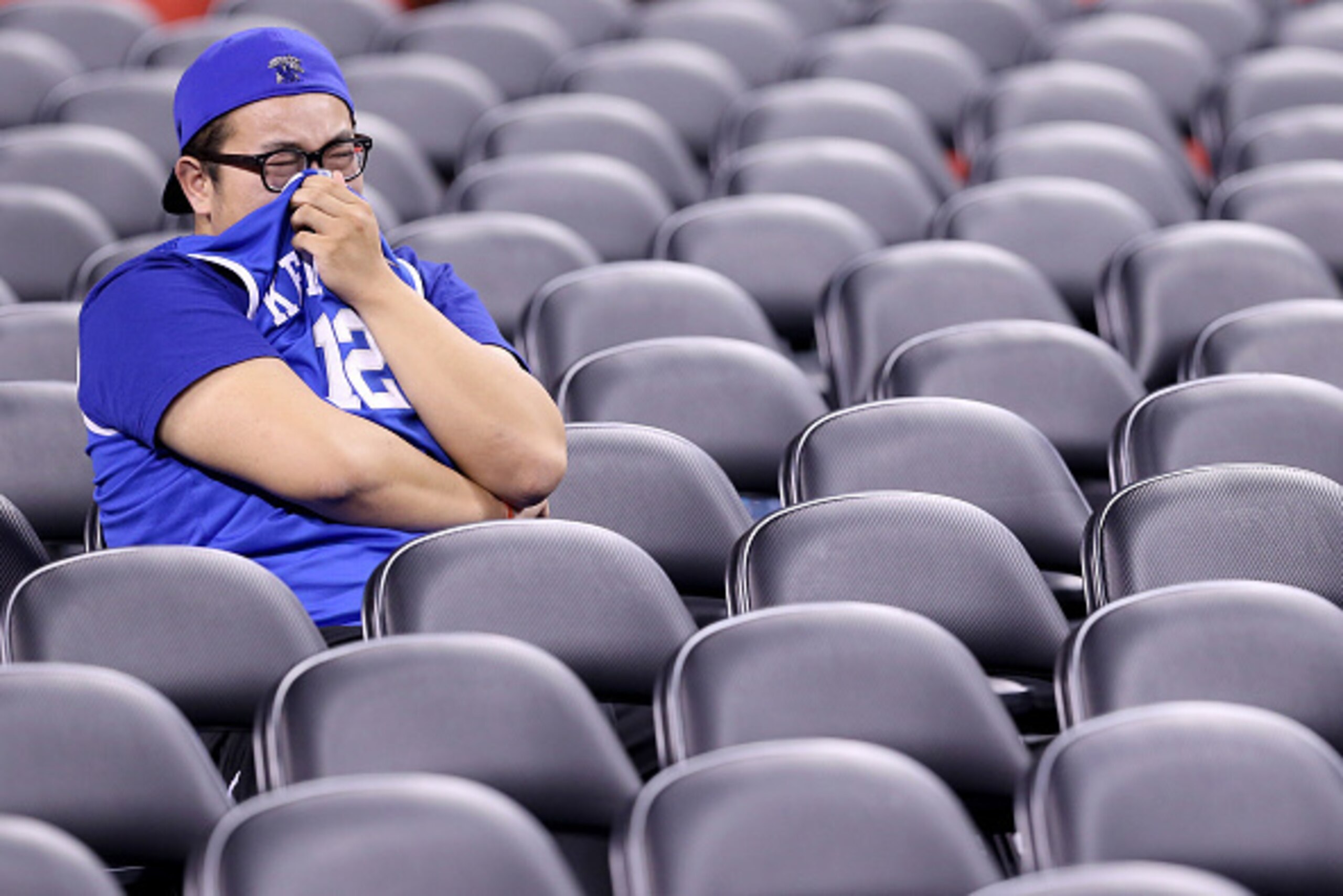INDIANAPOLIS, IN - APRIL 04: A Kentucky Wildcats fan reacts in the stands after being defeated by the Wisconsin Badgers during the NCAA Men's Final Four Semifinal at Lucas Oil Stadium on April 4, 2015 in Indianapolis, Indiana. Wisconsin defeated Kentucky INDIANAPOLIS, IN - APRIL 04: A Kentucky Wildcats fan reacts in the stands after being defeated by the Wisconsin Badgers during the NCAA Men's Final Four Semifinal at Lucas Oil Stadium on April 4, 2015 in Indianapolis, Indiana. Wisconsin defeated Kentucky